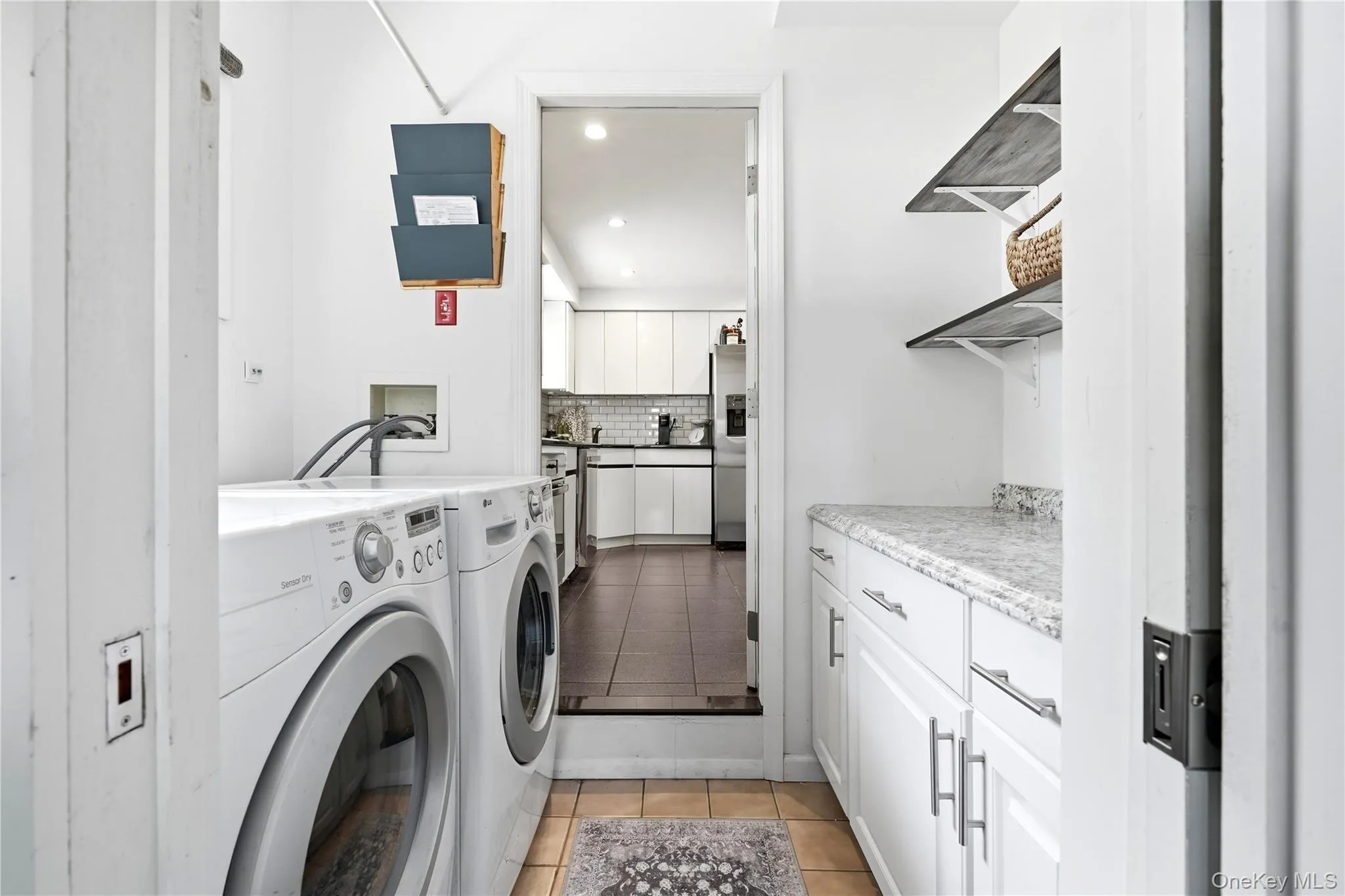 Laundry area off kitchen with additional room Laundry area off kitchen with additional room