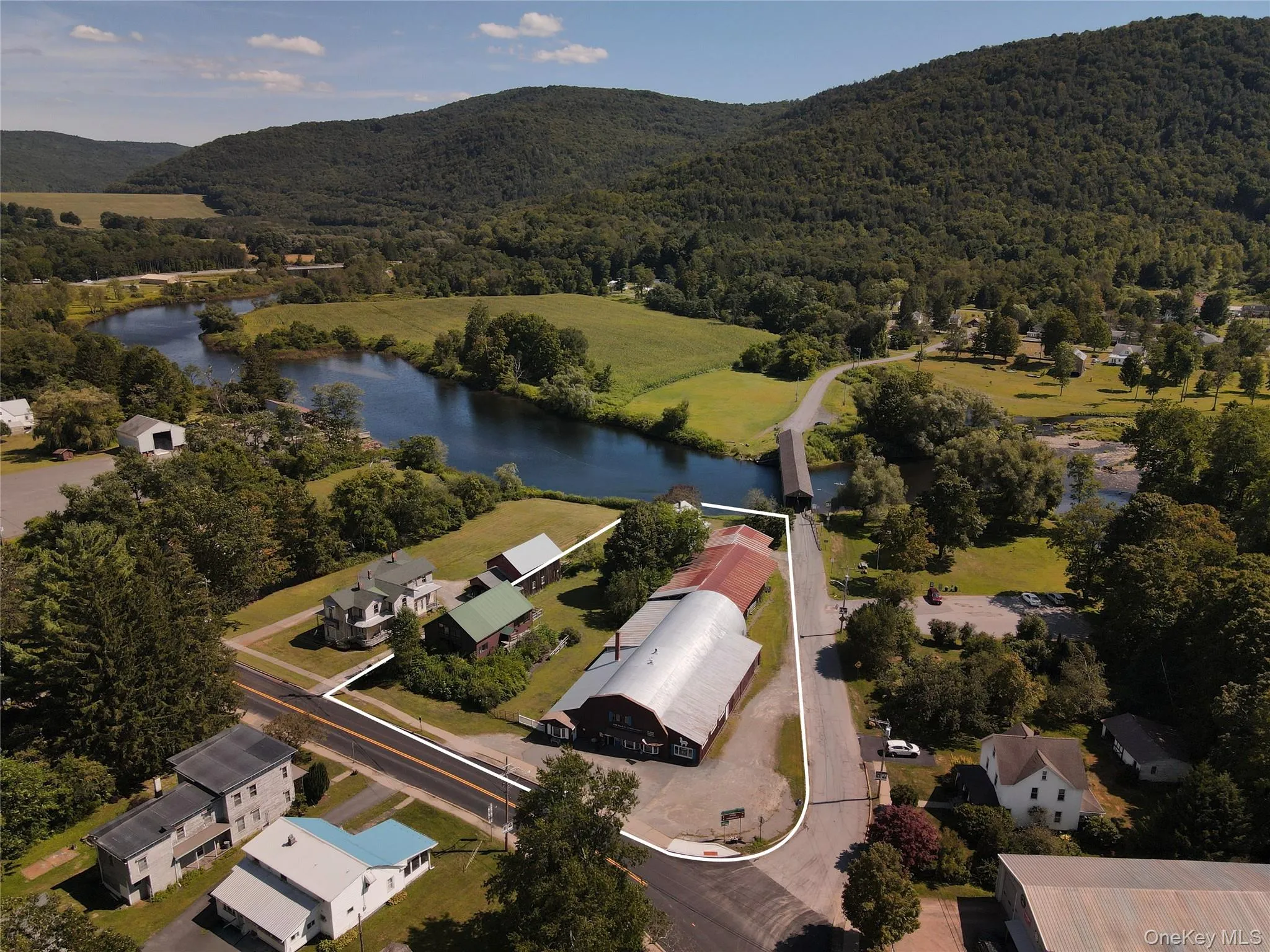 Aerial overview of property's location featuring a water and mountain view Aerial overview of property's location featuring a water and mountain view