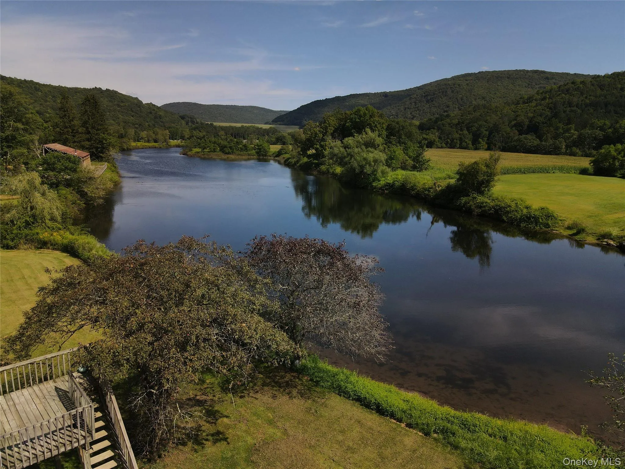 Water view with a mountain backdrop and a heavily wooded area Water view with a mountain backdrop and a heavily wooded area