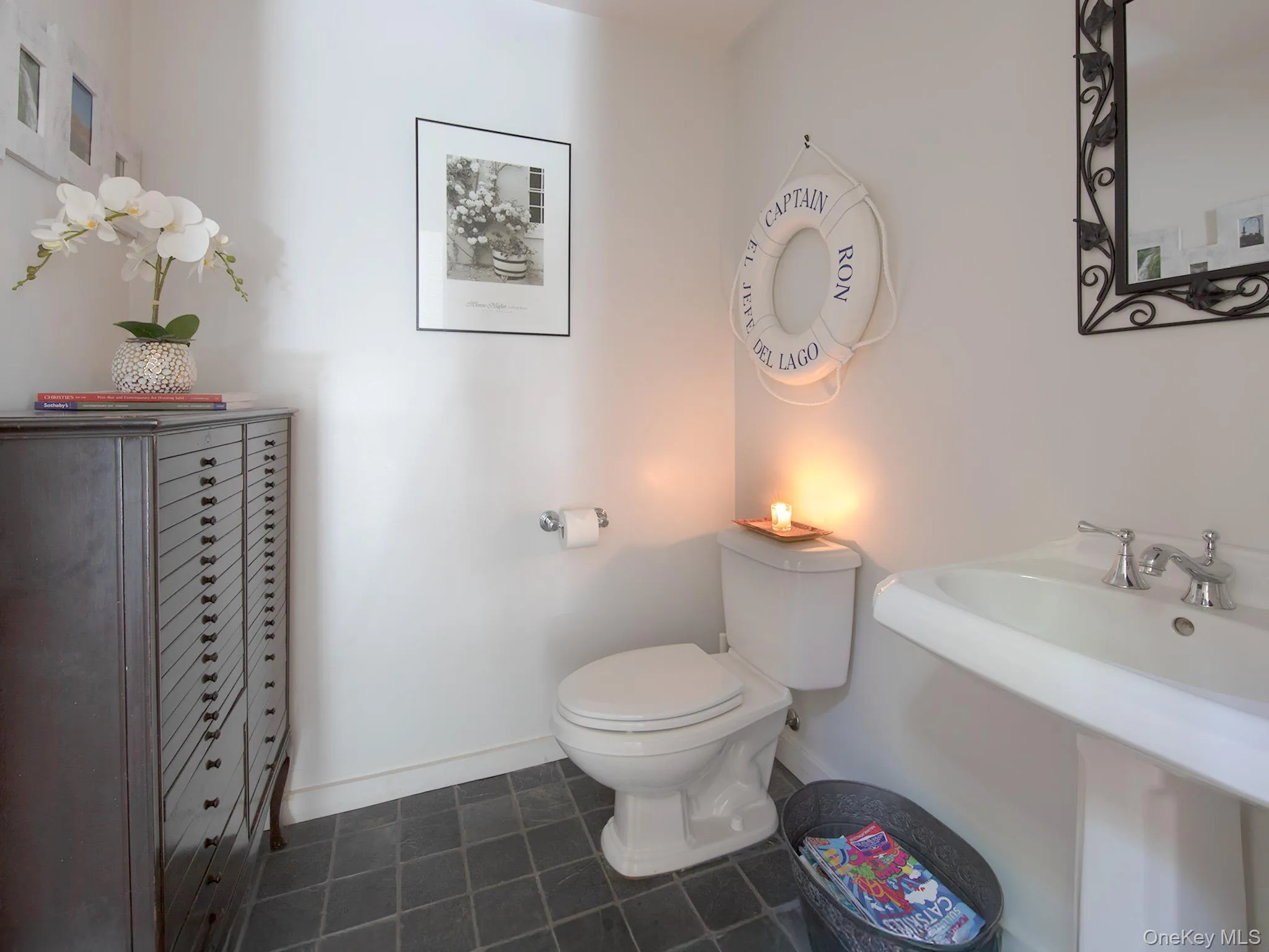 Bathroom with dark tile patterned floors and toilet Bathroom with dark tile patterned floors and toilet