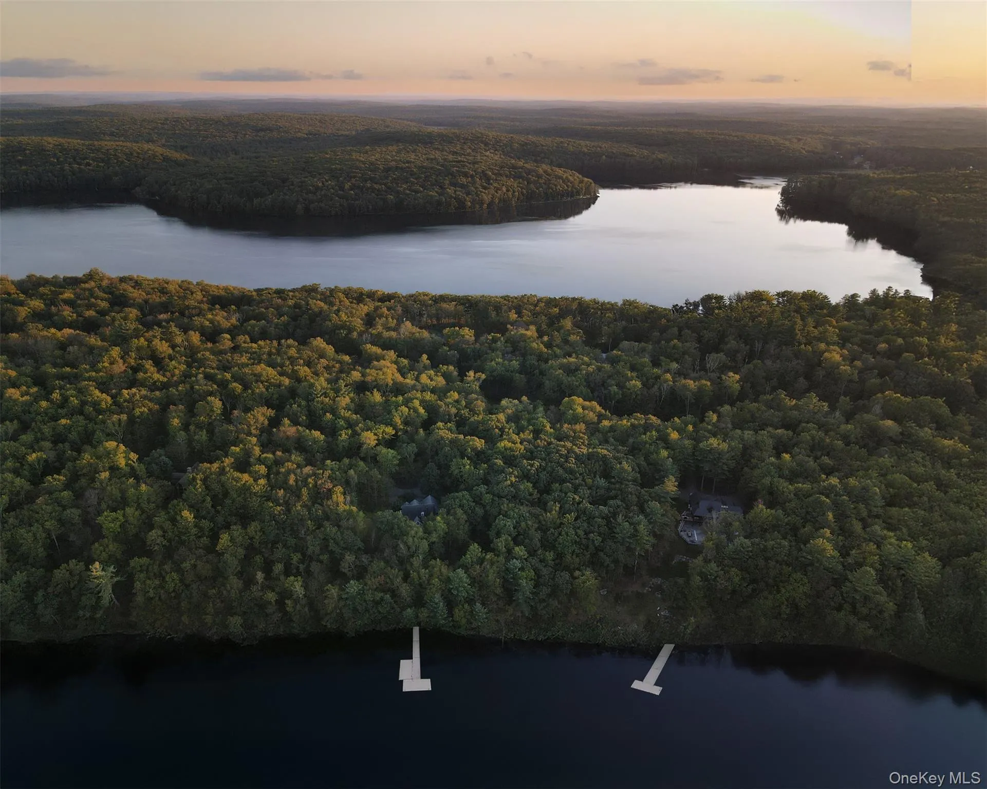 Aerial view at dusk of a water view and a view of trees Aerial view at dusk of a water view and a view of trees