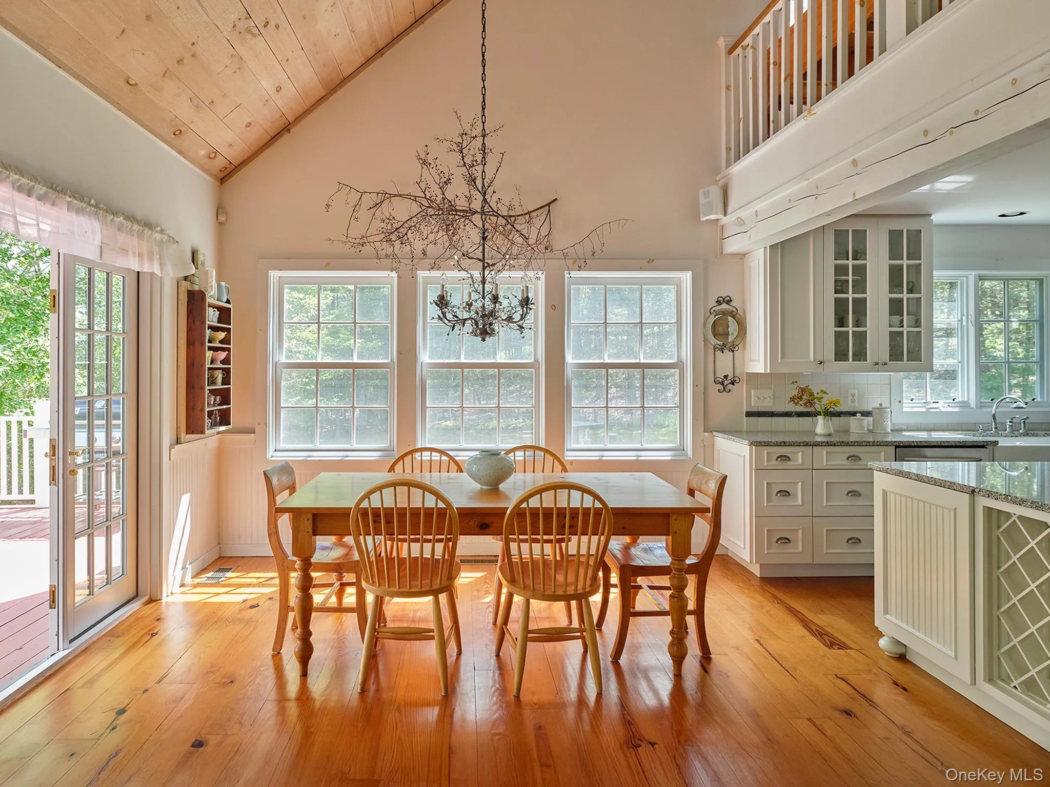 Dining area featuring light wood-style floors, high vaulted ceiling, wooden ceiling, and a chandelier Dining area featuring light wood-style floors, high vaulted ceiling, wooden ceiling, and a chandelier