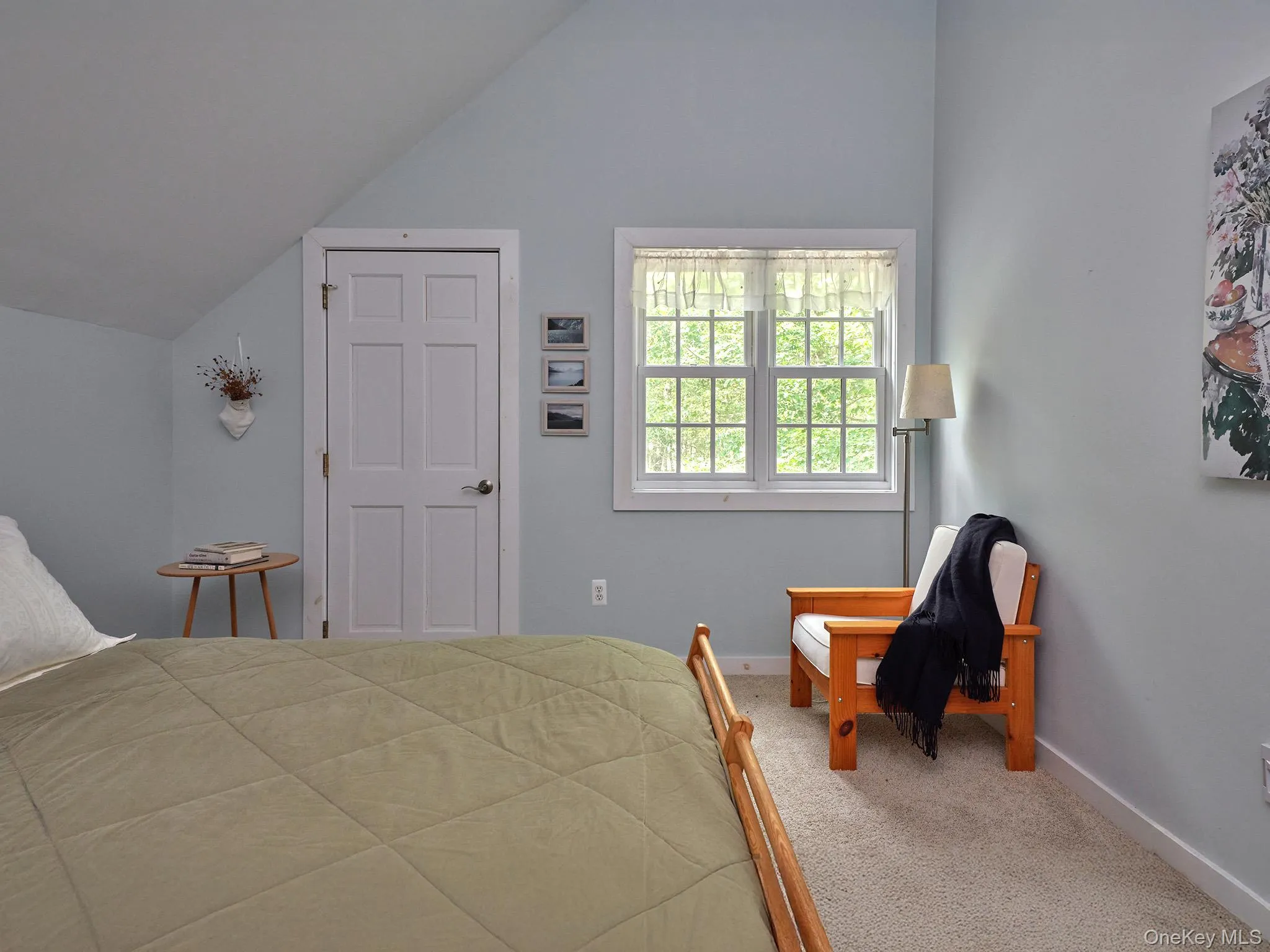 Bedroom with carpet floors and lofted ceiling Bedroom with carpet floors and lofted ceiling
