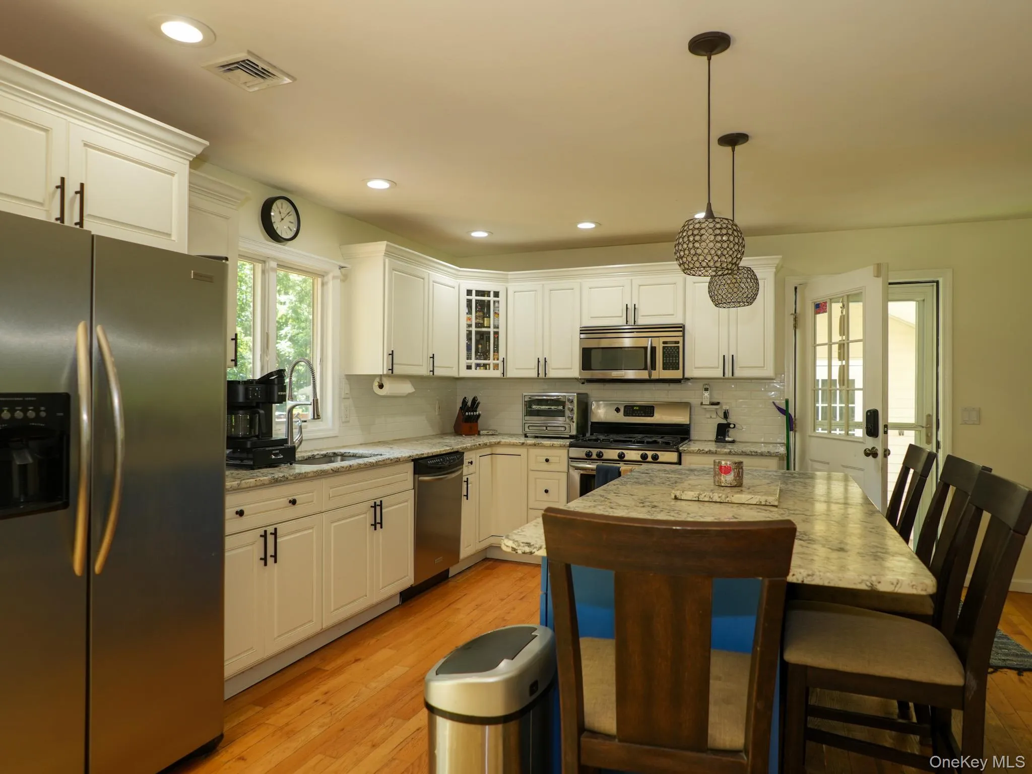 Plenty of room at the counter as family and friends gather to find out what's cooking in the kitchen. Plenty of room at the counter as family and friends gather to find out what's cooking in the kitchen.