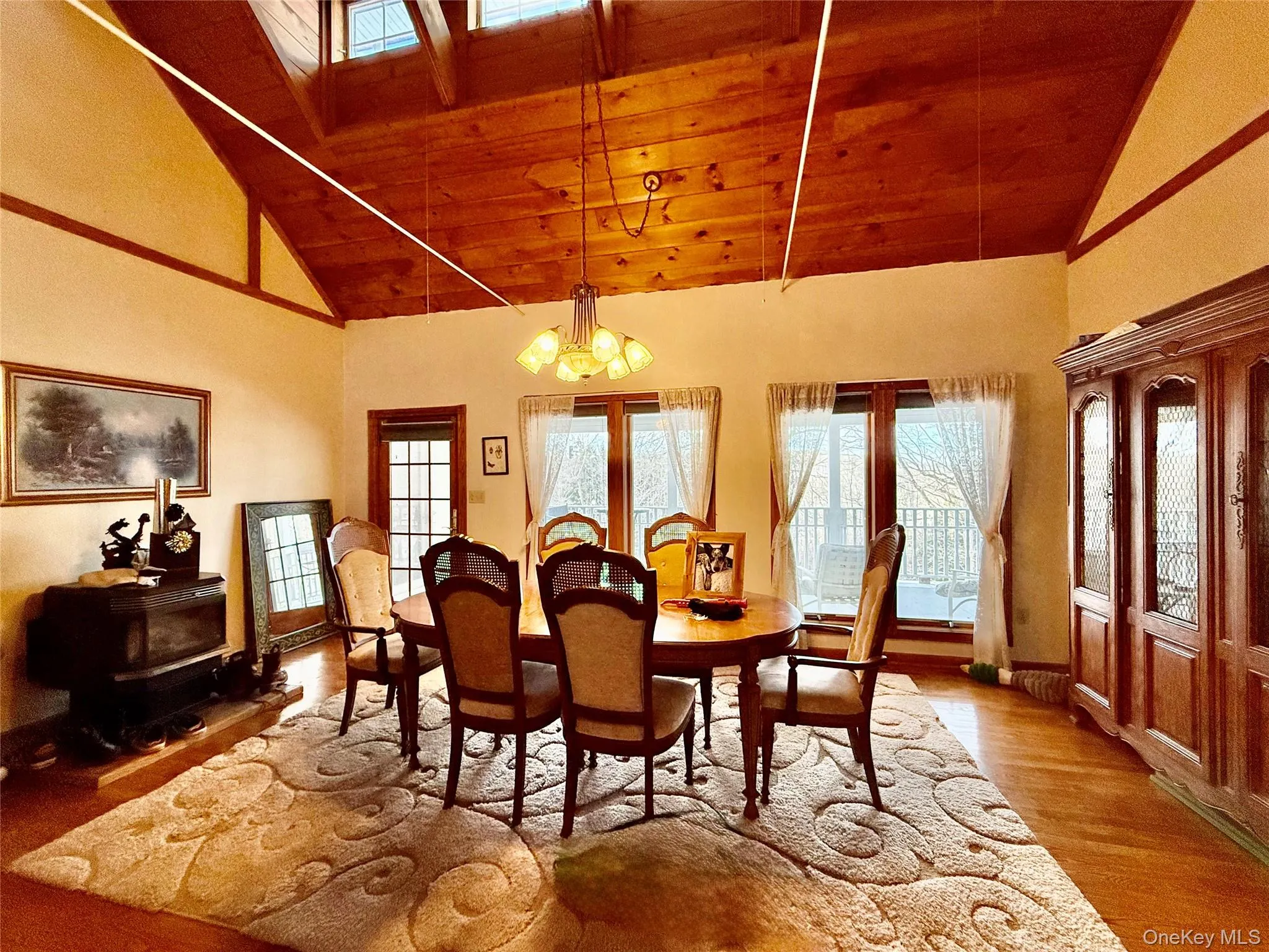 Dining area with hanging lights, wood finished floors, a vaulted wood ceiling Dining area with hanging lights, wood finished floors, a vaulted wood ceiling