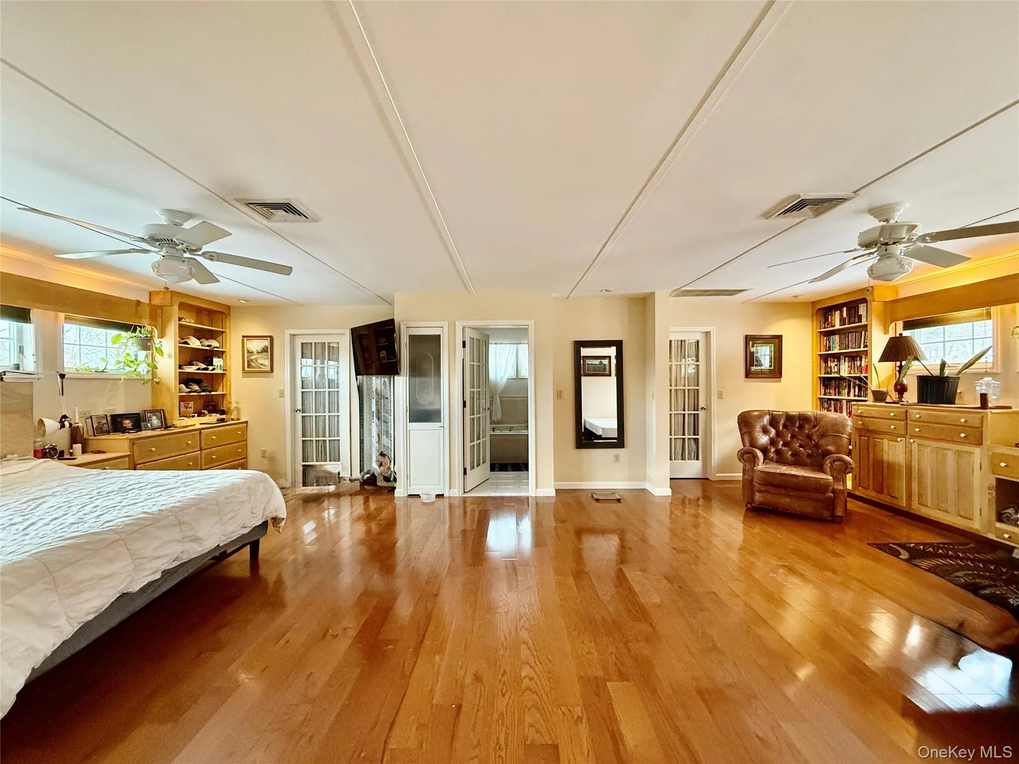 Bedroom with a ceiling fan and light wood-style flooring Bedroom with a ceiling fan and light wood-style flooring