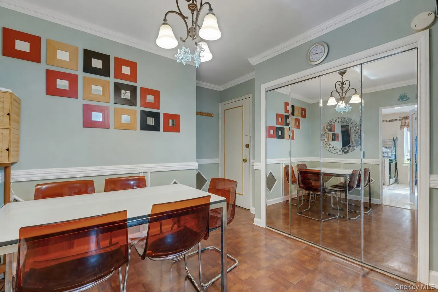 Dining area featuring wood-finish flooring, crown molding, and a chandelier Dining area featuring wood-finish flooring, crown molding, and a chandelier