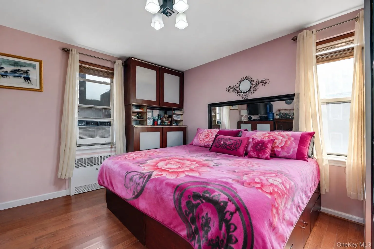 Wood-finish flooring complements light pink walls Wood-finish flooring complements light pink walls