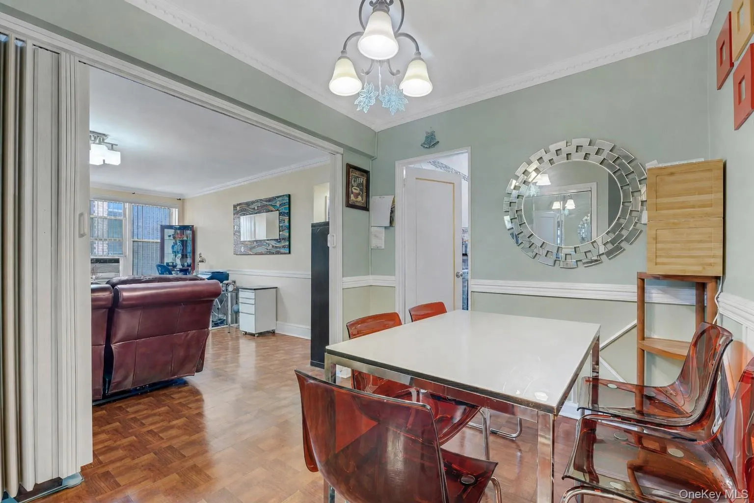 Dining area featuring wood-finish flooring, crown molding, and a chandelier Dining area featuring wood-finish flooring, crown molding, and a chandelier
