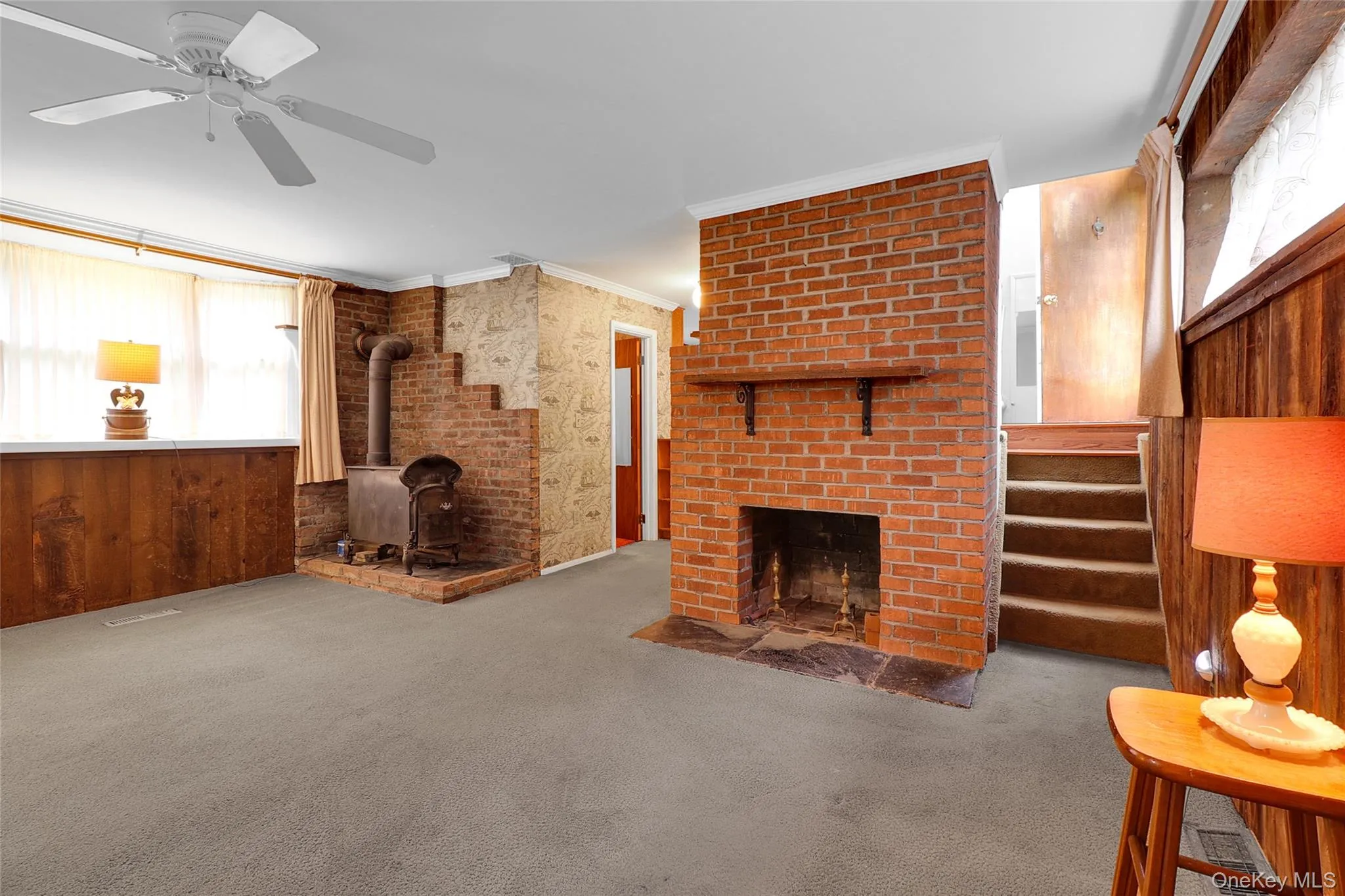Open fireplace with redbrick chimneyand a woodburning stove for great heat Open fireplace with redbrick chimneyand a woodburning stove for great heat