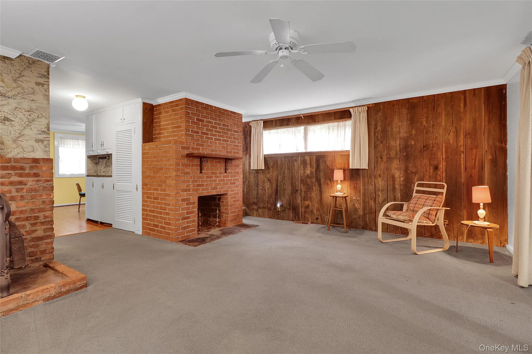 Large living room with wood paneled walls Large living room with wood paneled walls