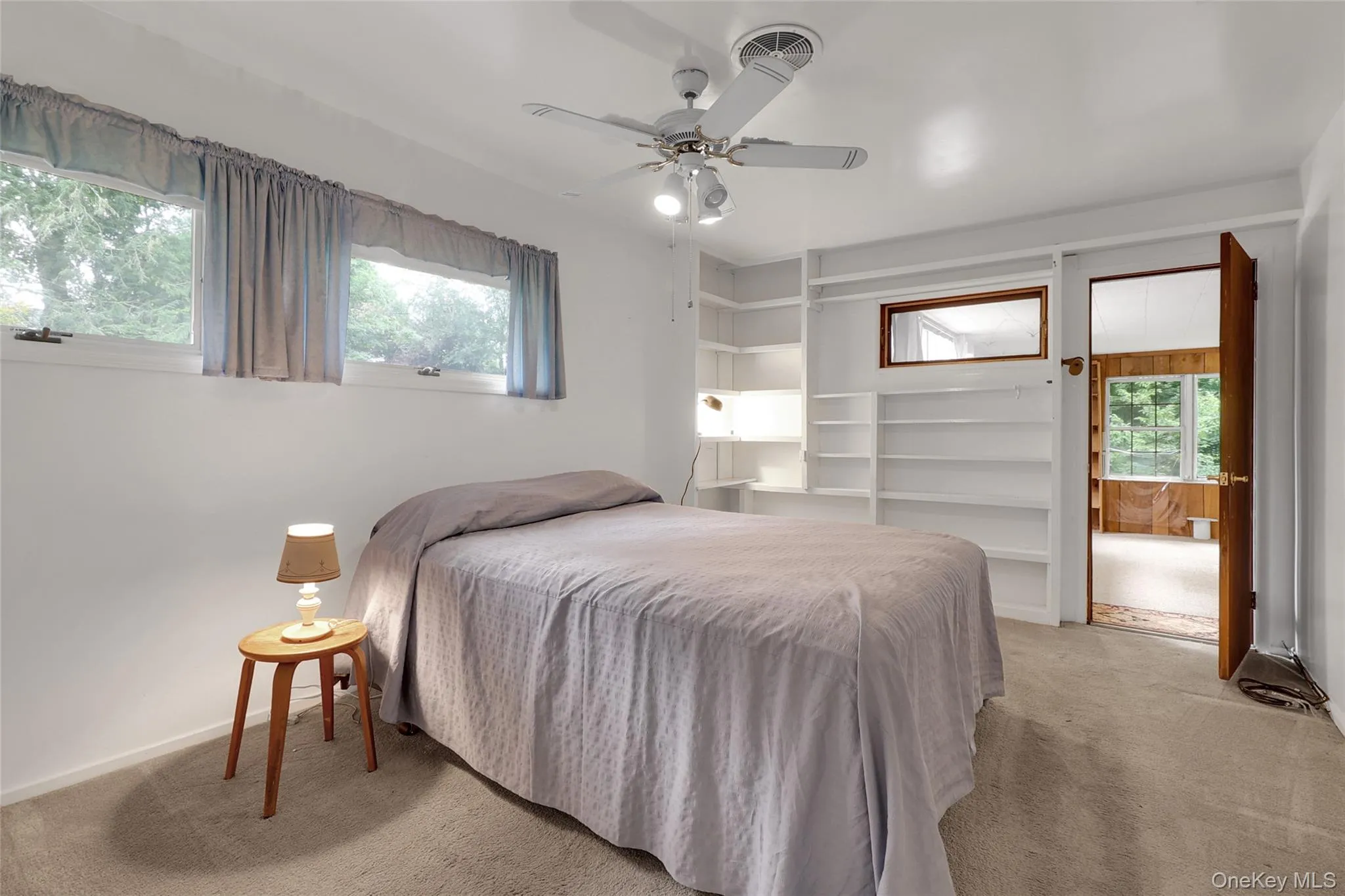 Primary bedroom with door to large additional 3 season sun room Primary bedroom with door to large additional 3 season sun room