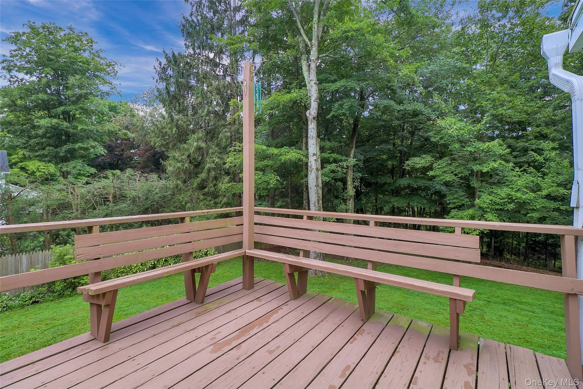 Open deck off primary bedroom/sunroom with wooded views Open deck off primary bedroom/sunroom with wooded views