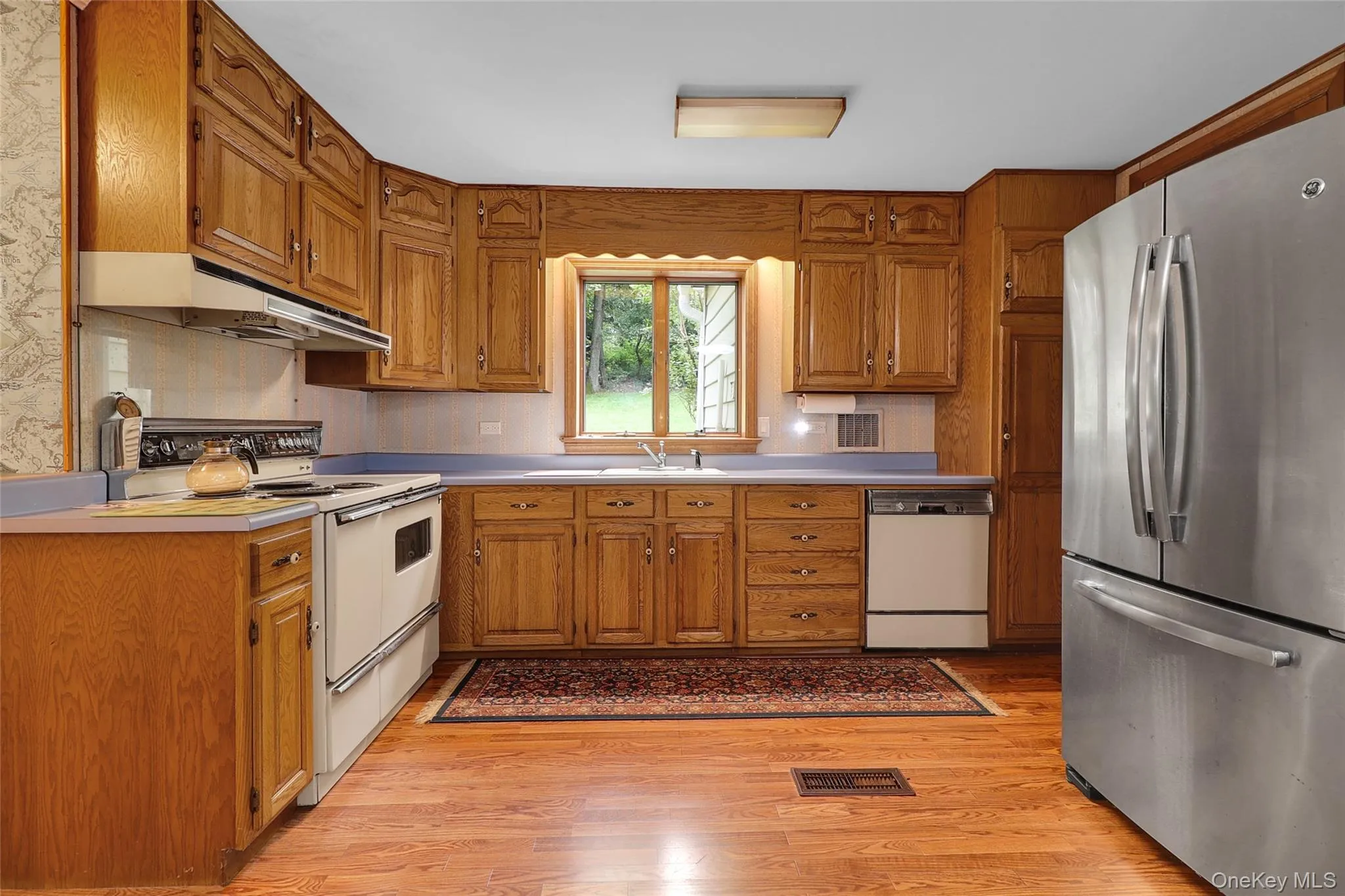 Spacious kitchen with stainless fridge freezer, stove and dishwasher Spacious kitchen with stainless fridge freezer, stove and dishwasher