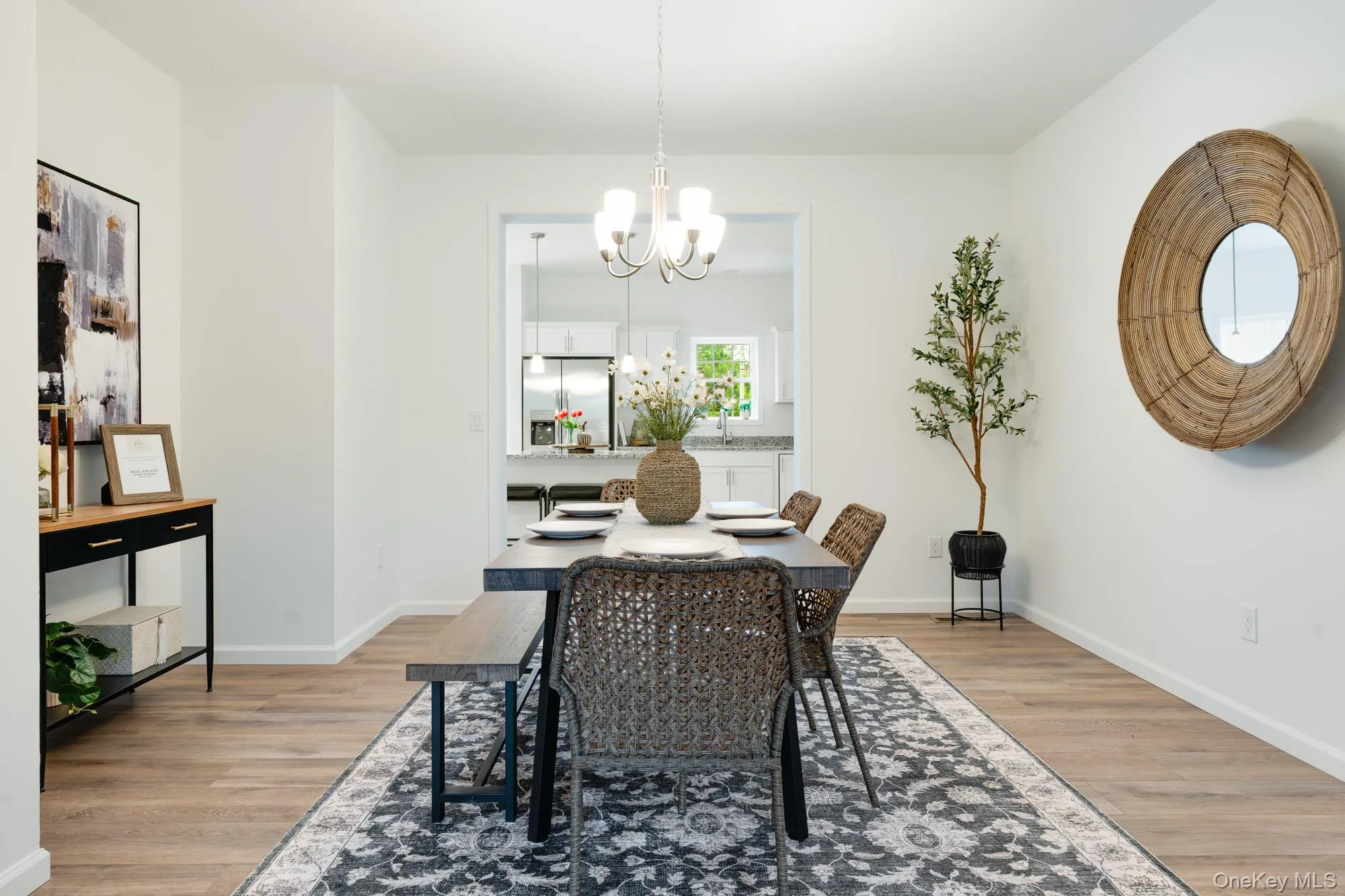 Dining space featuring a chandelier, light wood-type flooring Dining space featuring a chandelier, light wood-type flooring
