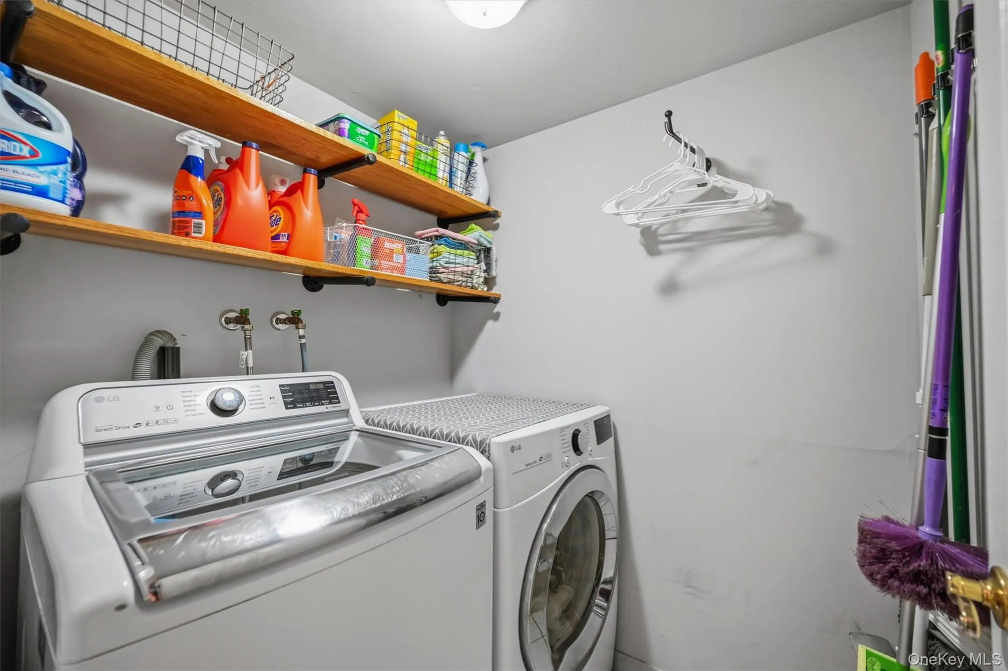 The first floor laundry room offers wood shelving and storage The first floor laundry room offers wood shelving and storage