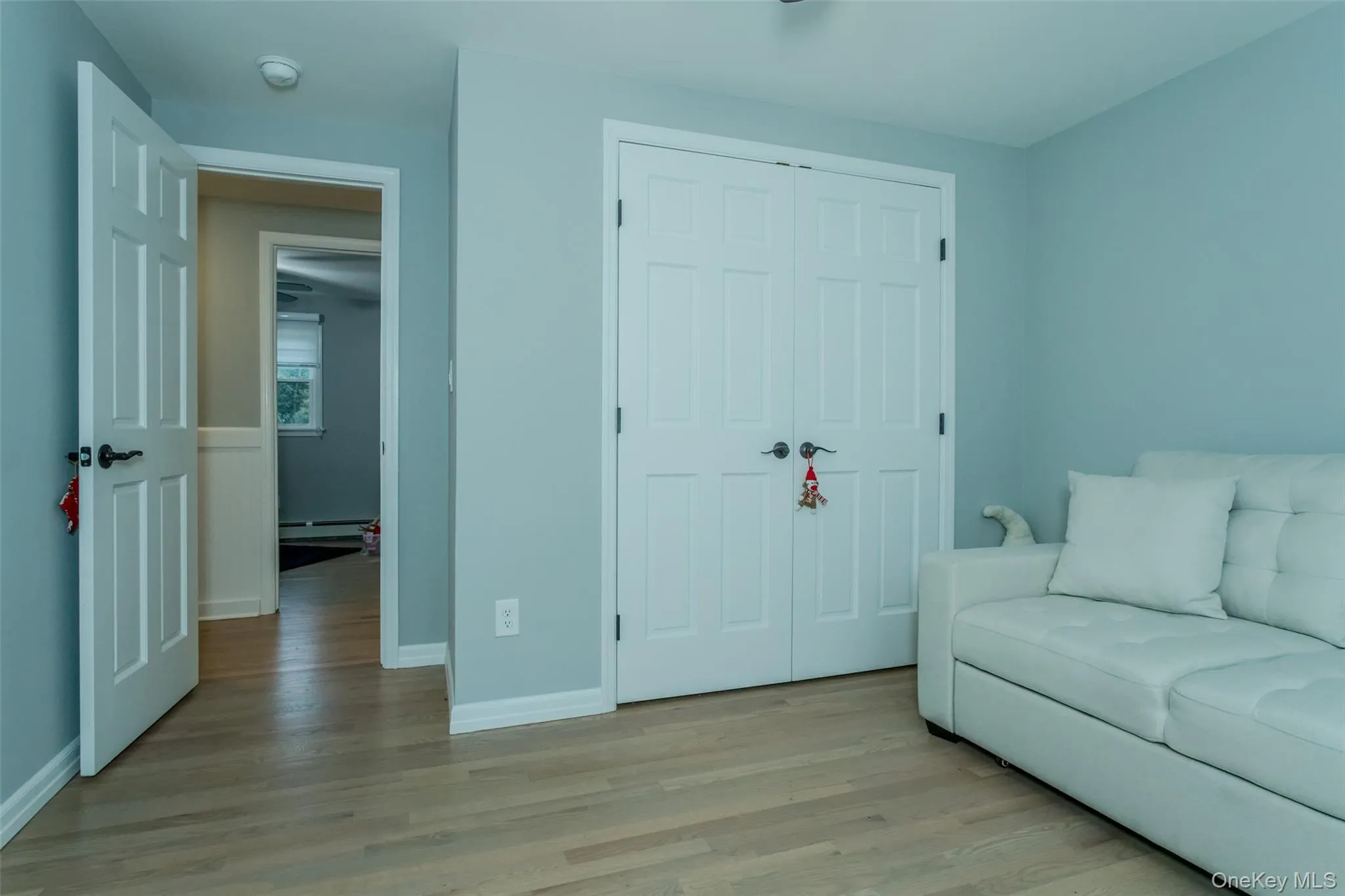 Sitting room featuring light hardwood / wood-style floors and a baseboard radiator Sitting room featuring light hardwood / wood-style floors and a baseboard radiator