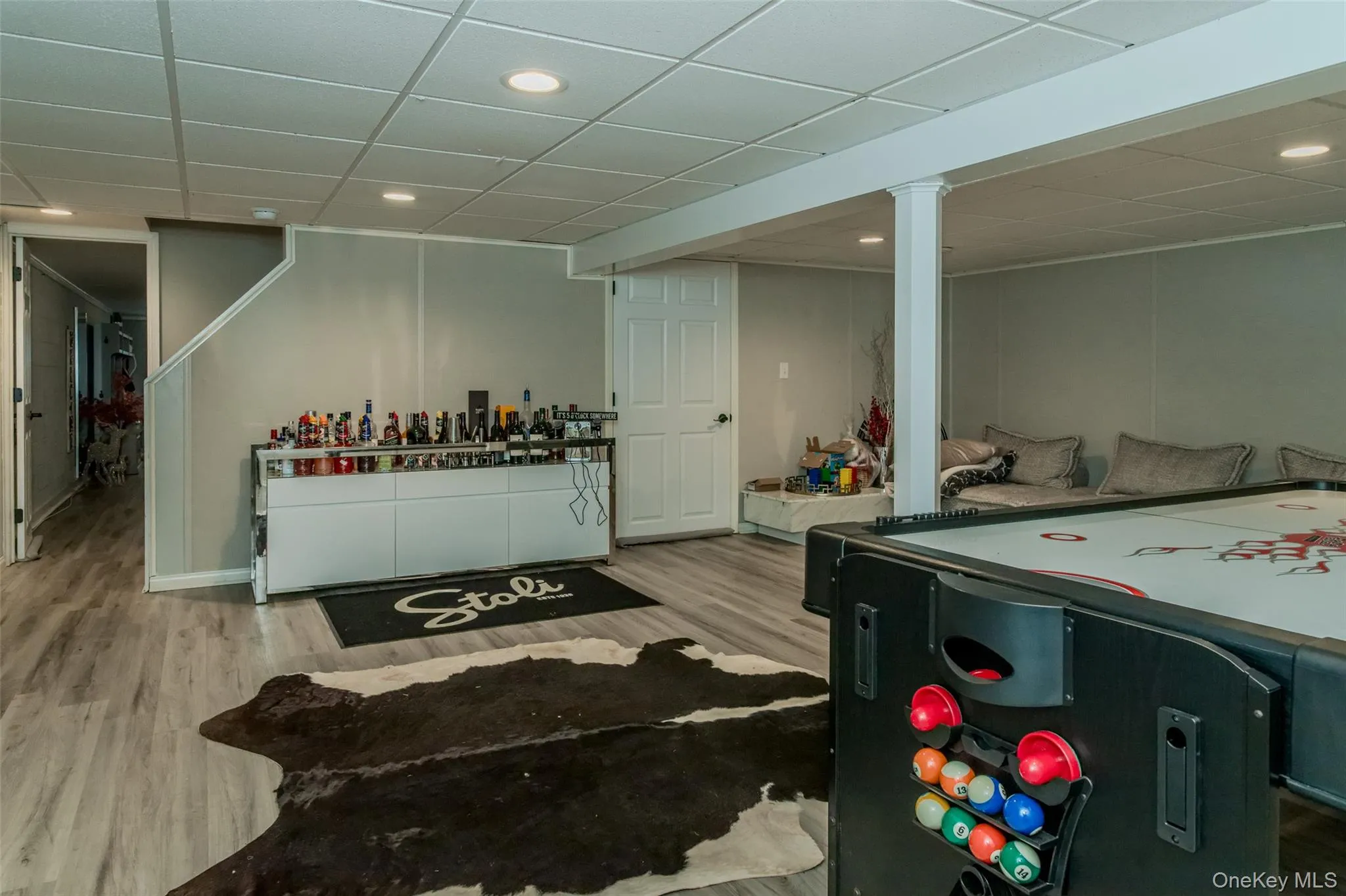 Rec room featuring a drop ceiling and light hardwood / wood-style floors Rec room featuring a drop ceiling and light hardwood / wood-style floors