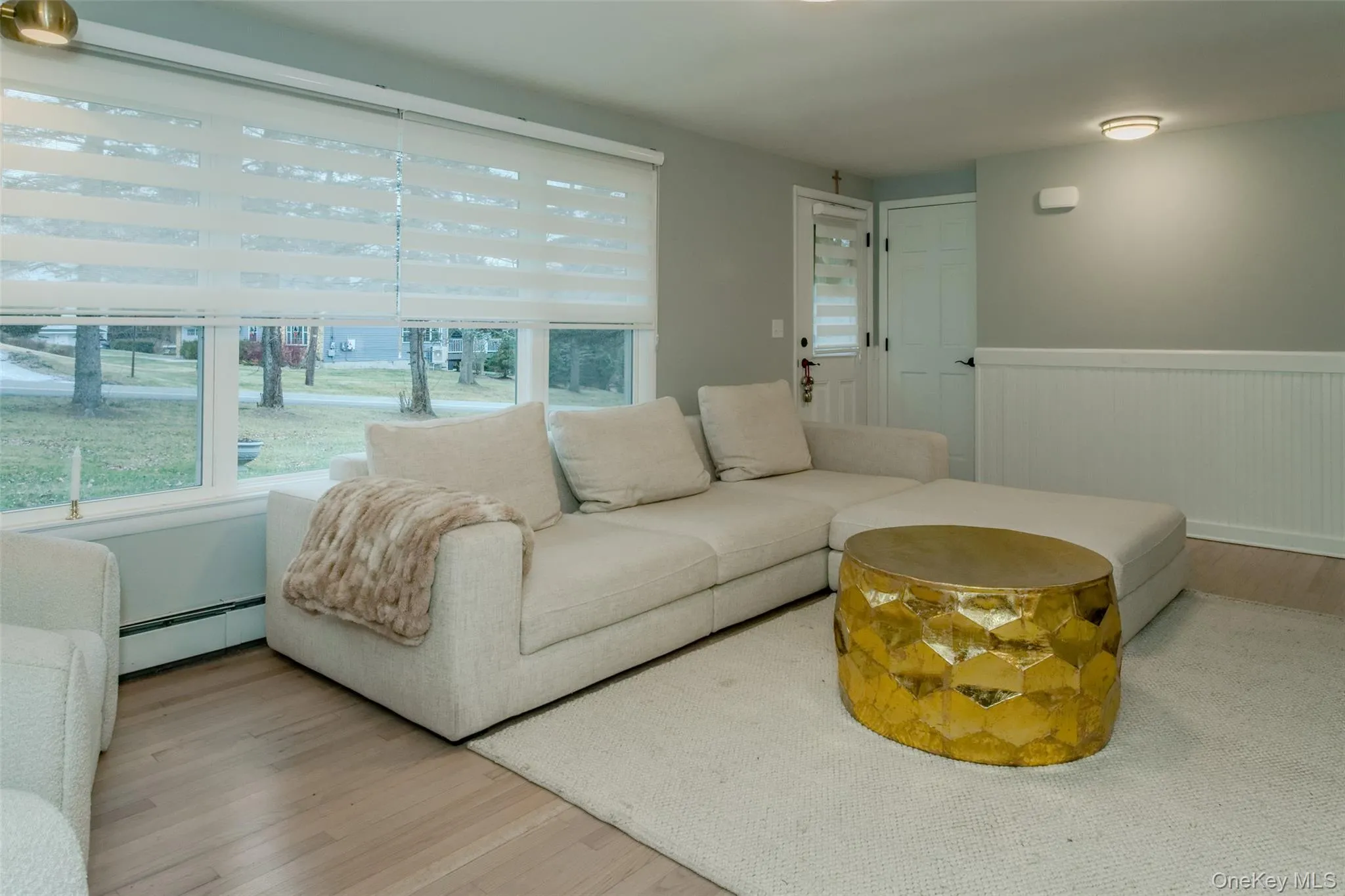 Living room featuring light hardwood / wood-style floors and baseboard heating Living room featuring light hardwood / wood-style floors and baseboard heating