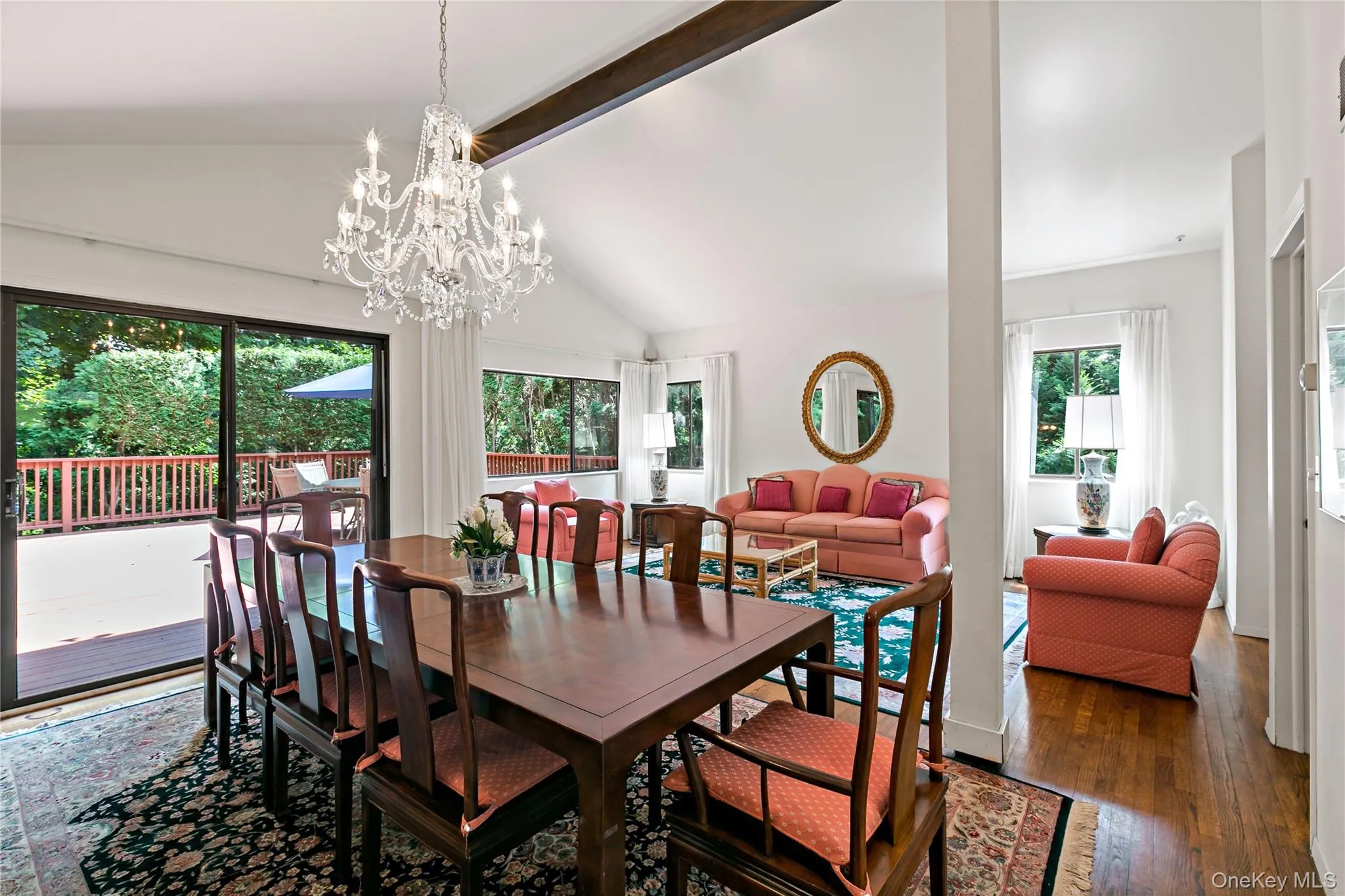 View of Dining Room and Living Room with sliding glass doors to deck. View of Dining Room and Living Room with sliding glass doors to deck.