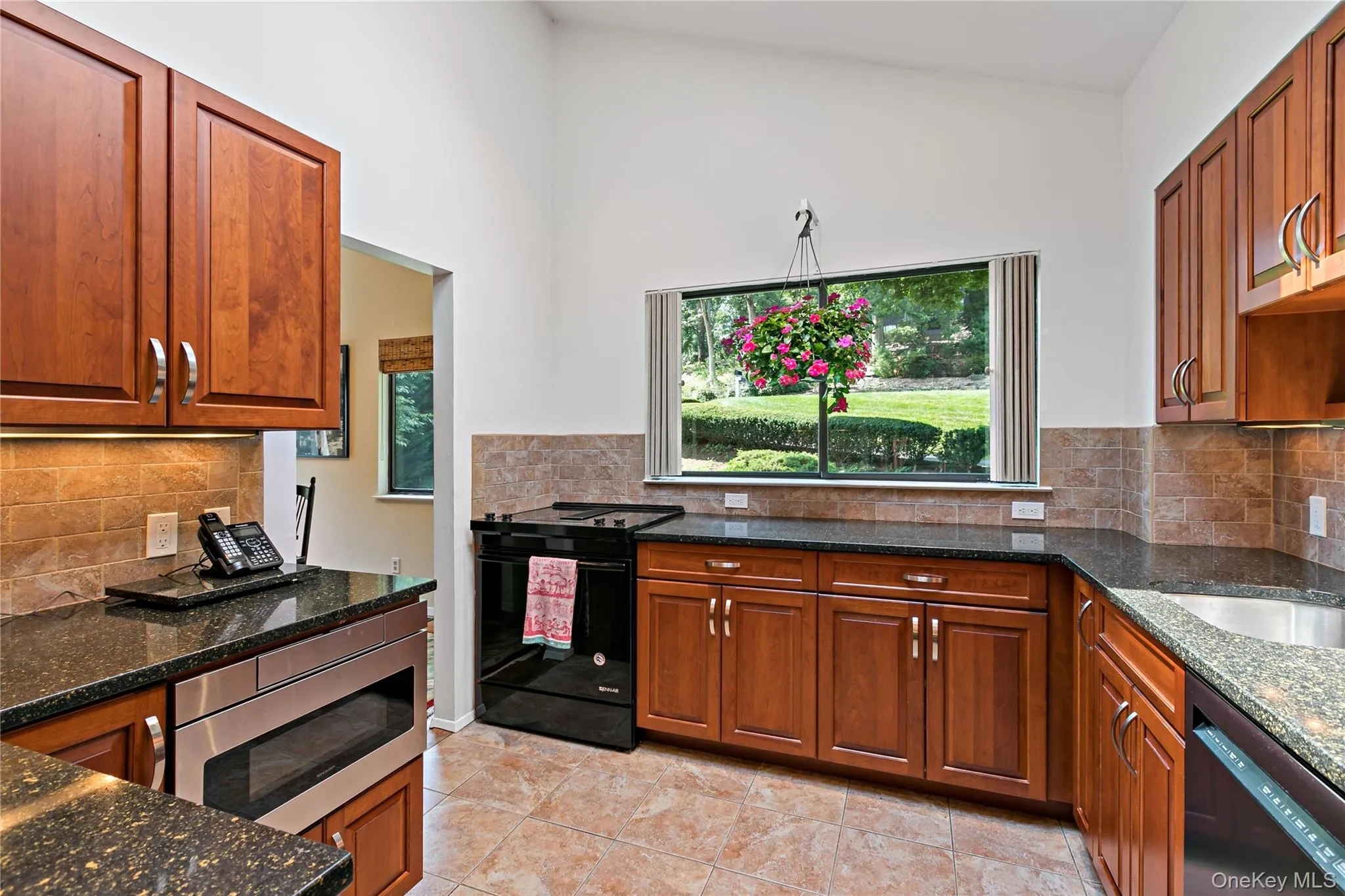 Sun-filled renovated kitchen with large window and skylight. This beautiful kitchen boasts Cherrywood Cabinetry and quartz counters. Sun-filled renovated kitchen with large window and skylight. This beautiful kitchen boasts Cherrywood Cabinetry and quartz counters.