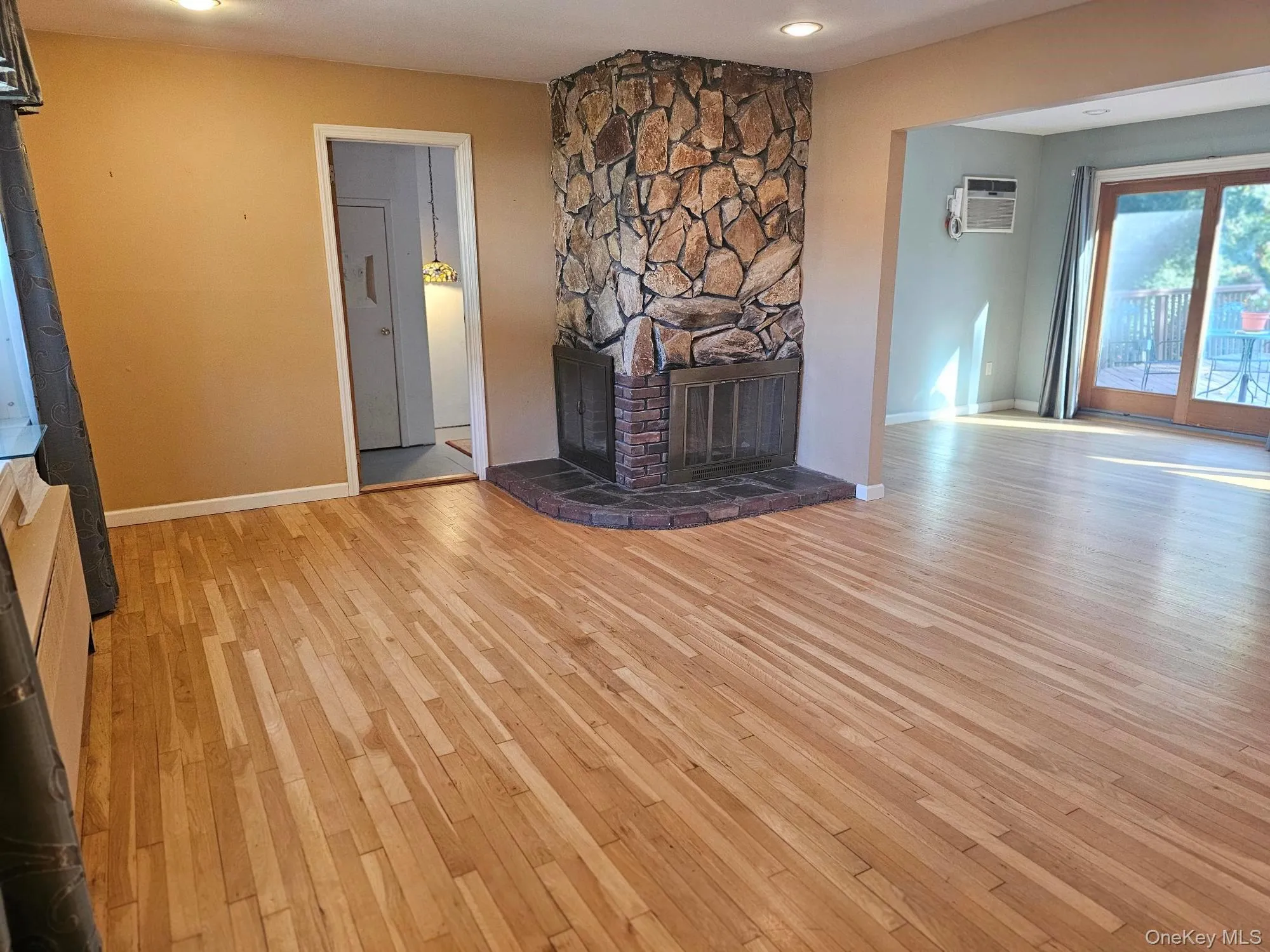 Vacant Living Room with Stone Fireplace Vacant Living Room with Stone Fireplace