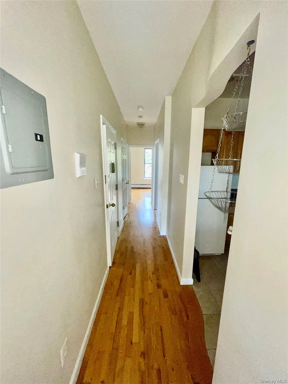 Corridor with electric panel and wood finished floors Corridor with electric panel and wood finished floors