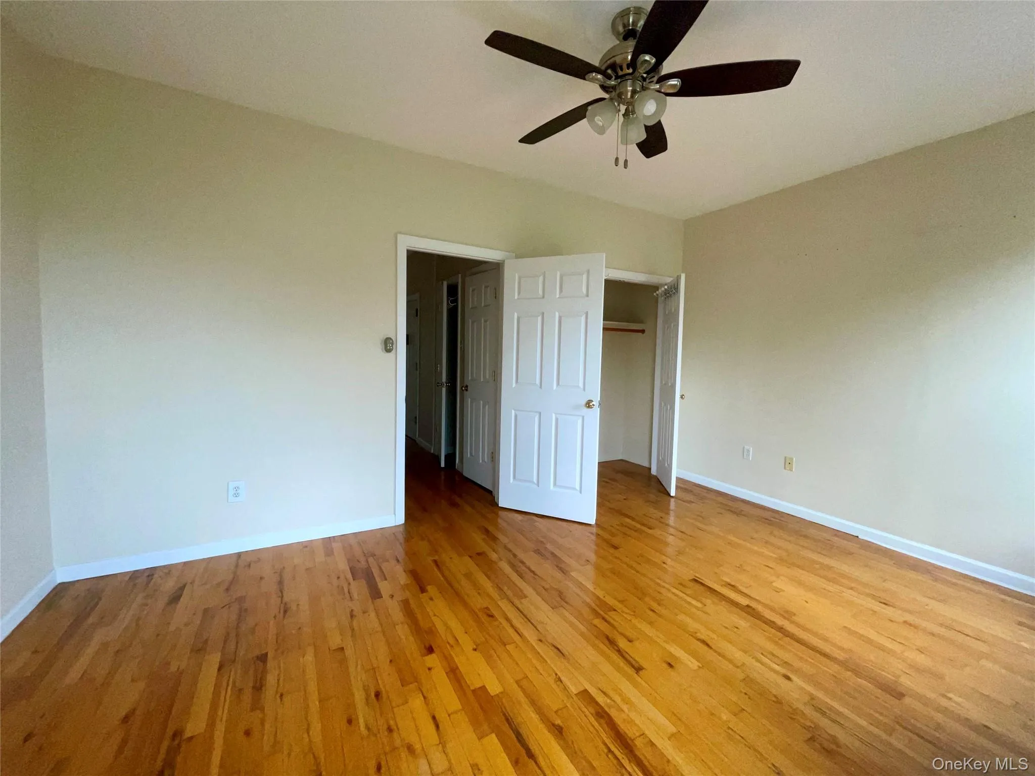 Unfurnished bedroom featuring light wood finished floors and a ceiling fan Unfurnished bedroom featuring light wood finished floors and a ceiling fan