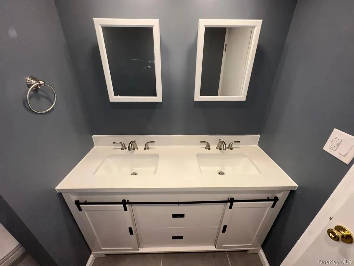 Bathroom with a sink, double vanity, and tile patterned flooring Bathroom with a sink, double vanity, and tile patterned flooring