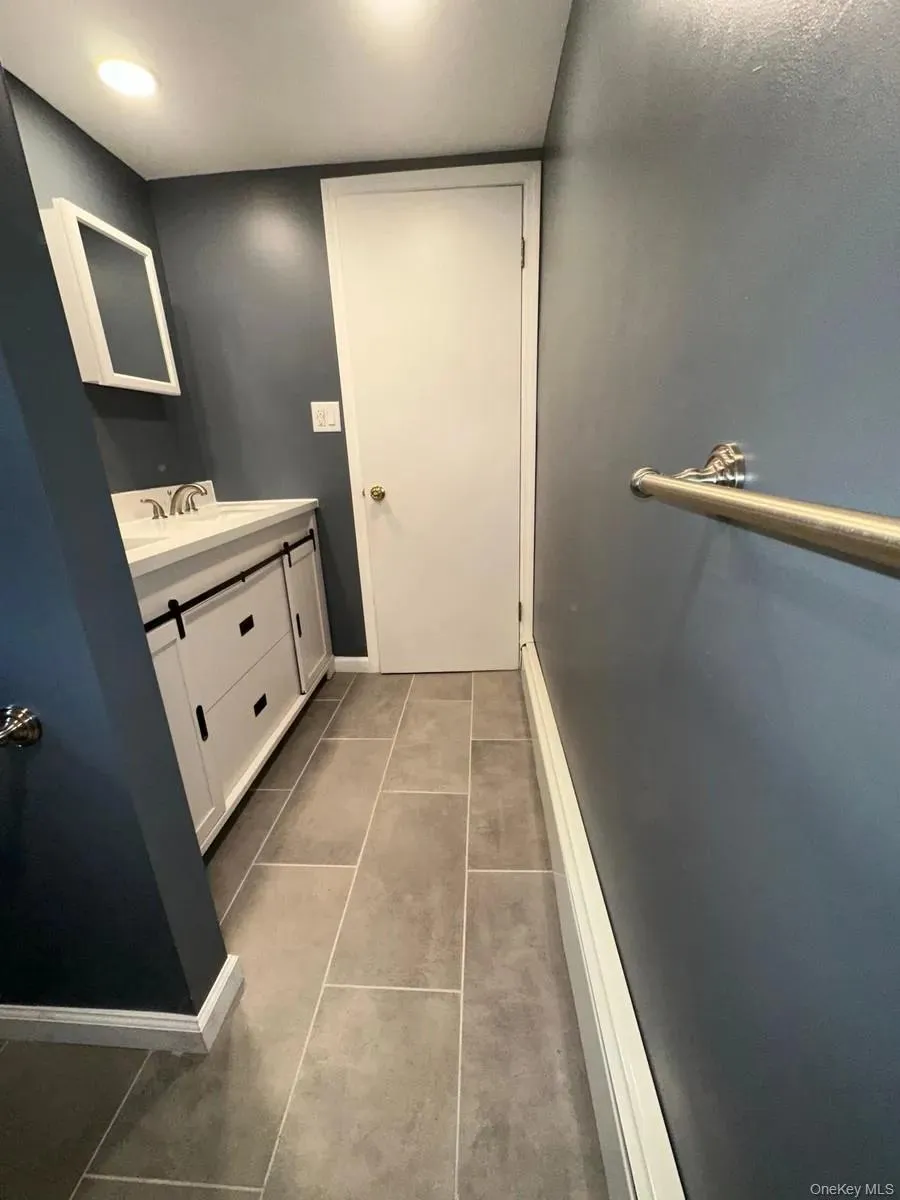 Bathroom featuring vanity and tile patterned flooring Bathroom featuring vanity and tile patterned flooring