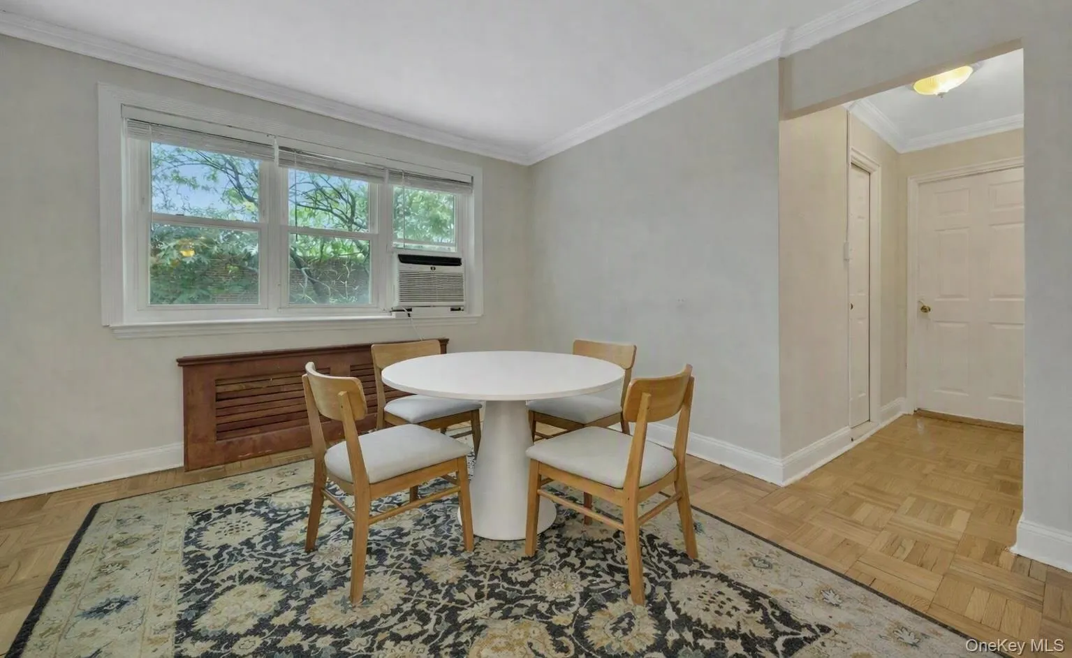 The far end of the living room with a virtually staged table to show the multiple functions of this large room The far end of the living room with a virtually staged table to show the multiple functions of this large room