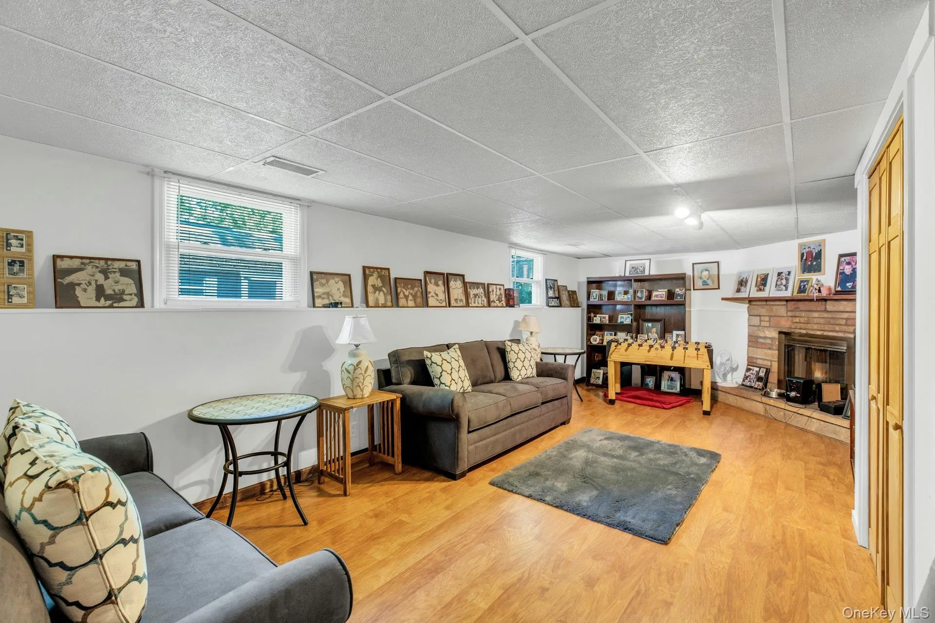 Finished Basement Family Room featuring warm wood-finish flooring, recessed ceiling lighting, and abundant wall space for display Finished Basement Family Room featuring warm wood-finish flooring, recessed ceiling lighting, and abundant wall space for display