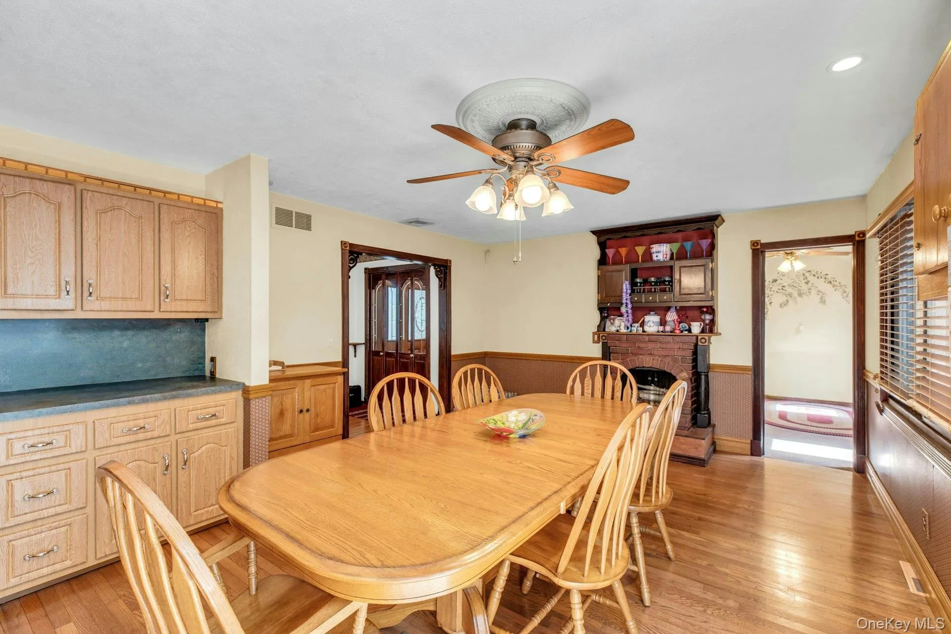 Dining area featuring wood-finish flooring and a ceiling fan with light fixture Dining area featuring wood-finish flooring and a ceiling fan with light fixture