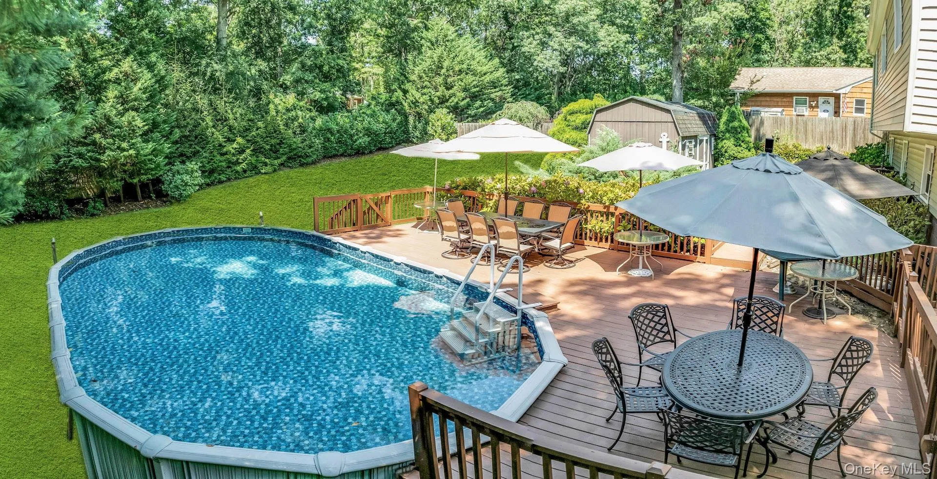 Expansive rear deck featuring a pool with steps Expansive rear deck featuring a pool with steps