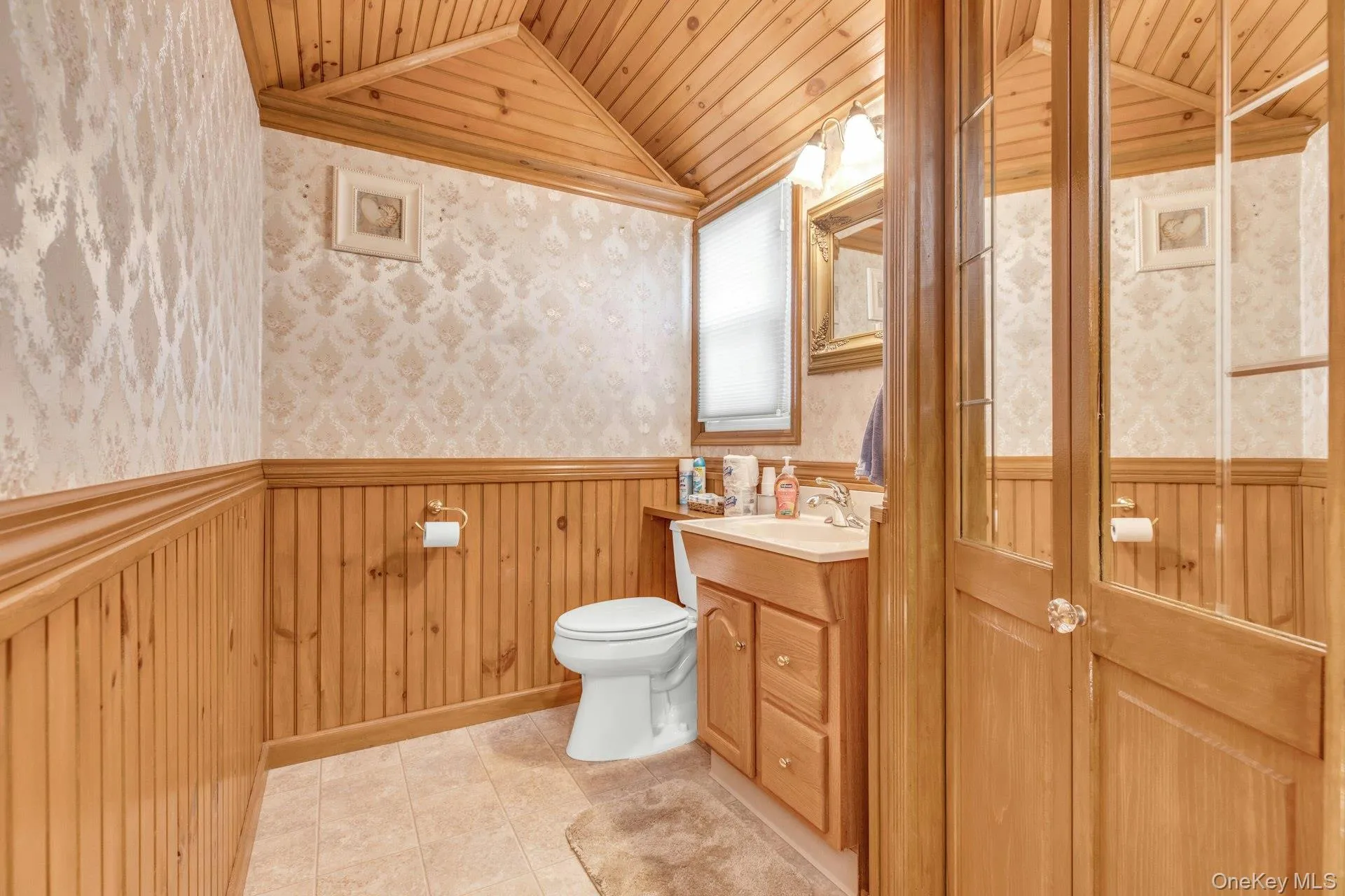 Bathroom featuring a paneled wood ceiling and wainscoting Bathroom featuring a paneled wood ceiling and wainscoting