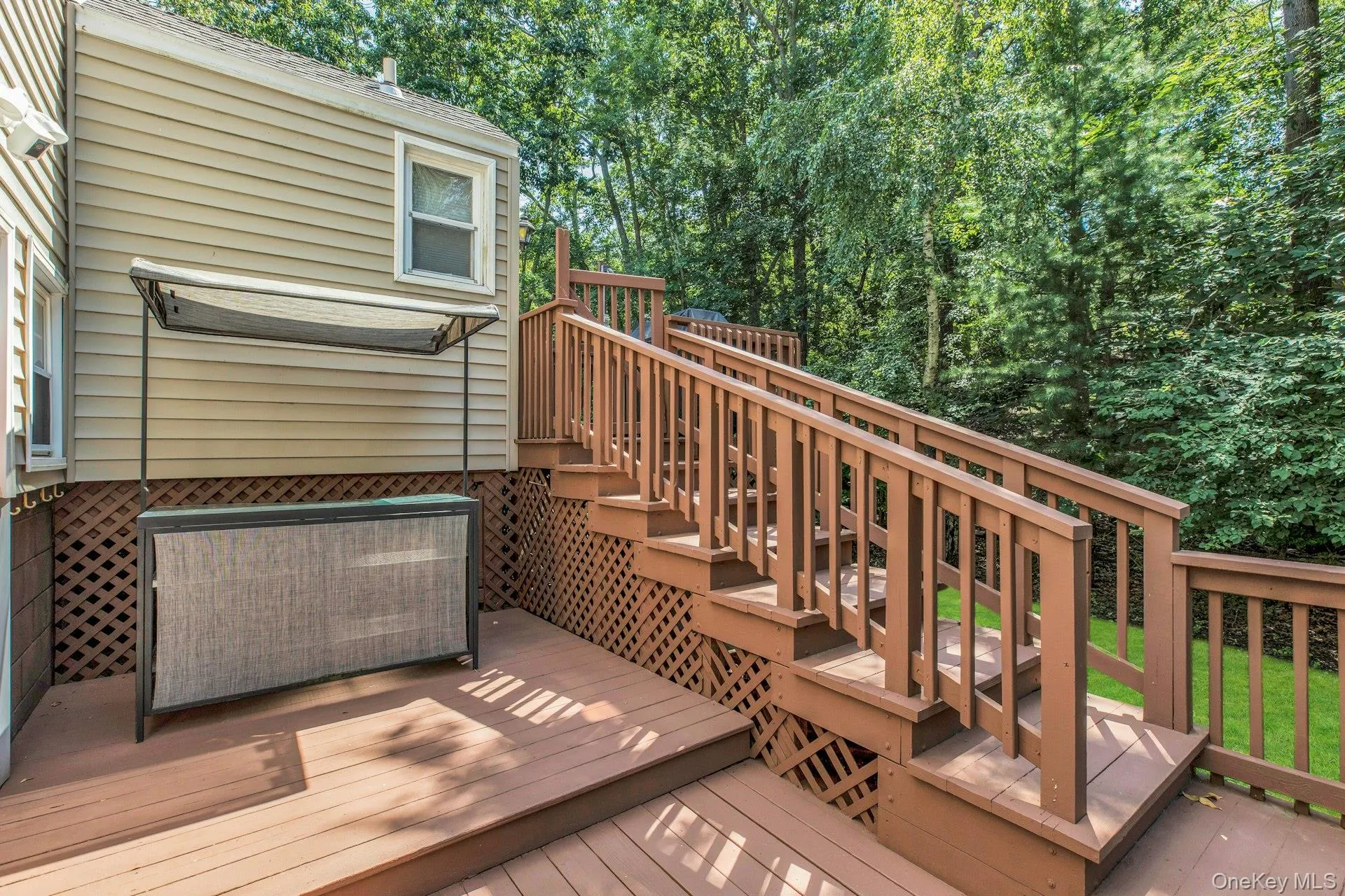 Multi-level wood deck featuring stained wood planking and railings Multi-level wood deck featuring stained wood planking and railings