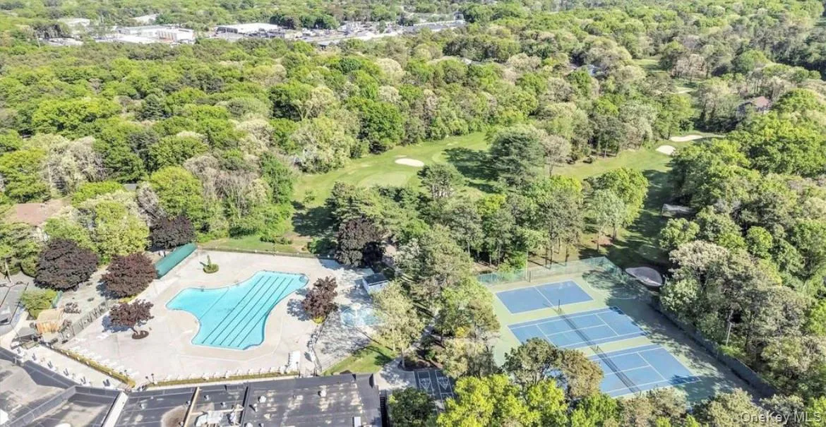 Extensive grounds featuring a large outdoor pool, multiple tennis courts, and bordering a golf course Extensive grounds featuring a large outdoor pool, multiple tennis courts, and bordering a golf course