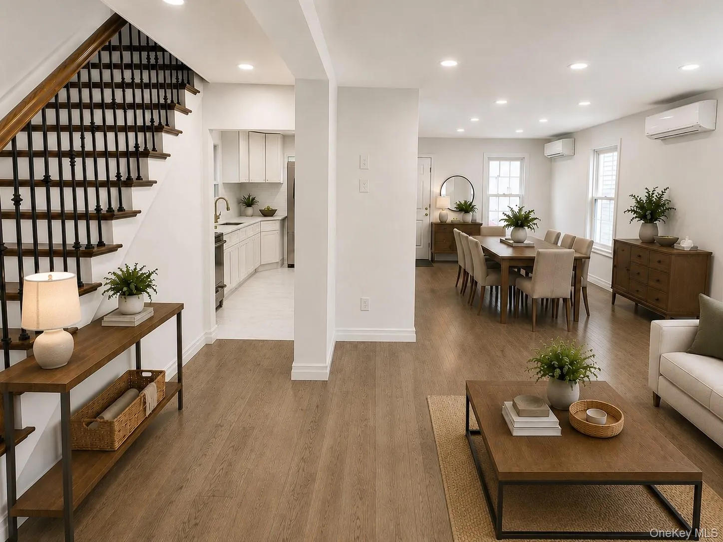 Open-concept living space featuring wood-finish flooring, recessed lighting, and white walls Open-concept living space featuring wood-finish flooring, recessed lighting, and white walls