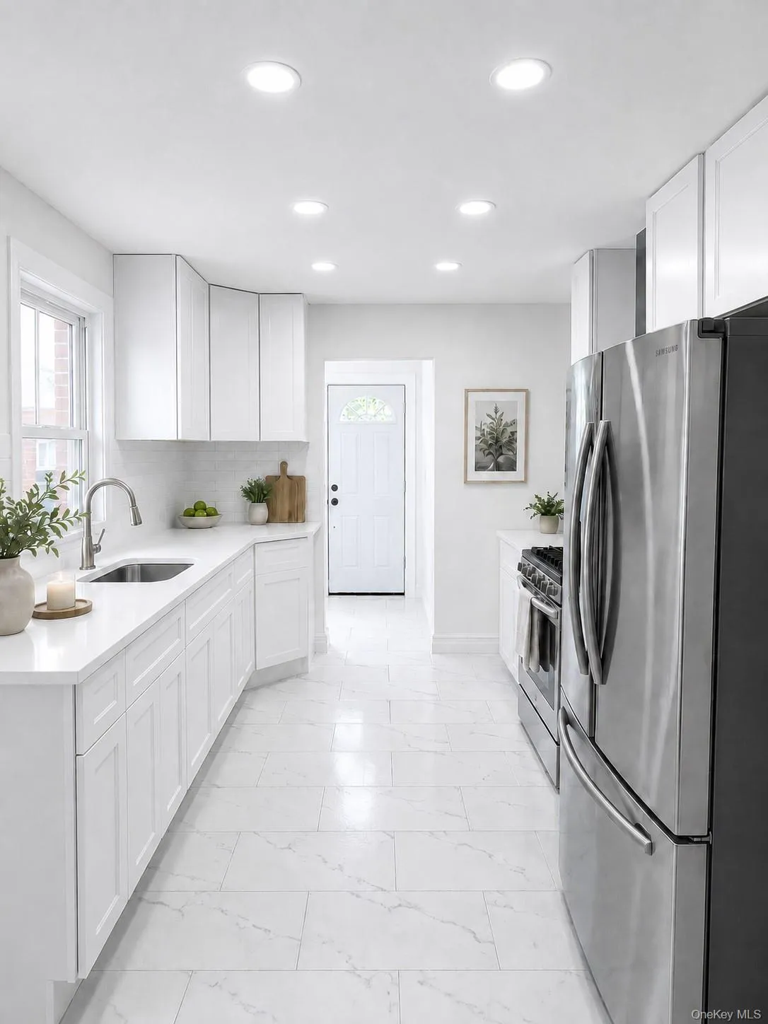 Bright kitchen featuring white cabinetry and stainless steel appliances Bright kitchen featuring white cabinetry and stainless steel appliances