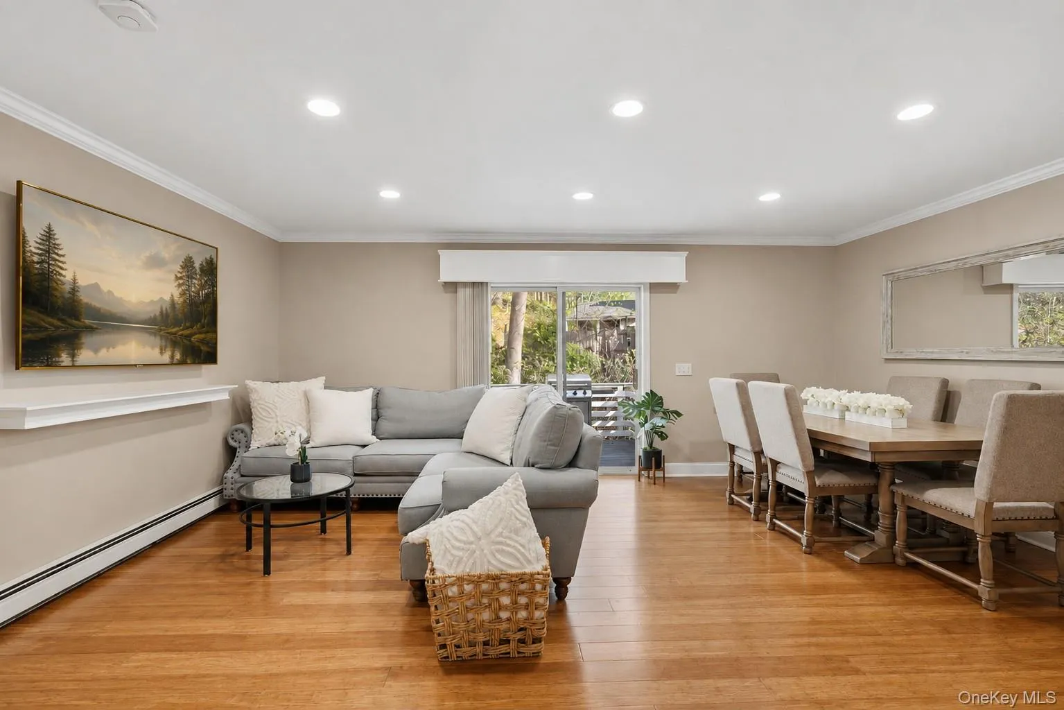 Recessed ceiling lighting, wood-finish flooring, sliding glass door, crown molding, and a decorative wall shelf Recessed ceiling lighting, wood-finish flooring, sliding glass door, crown molding, and a decorative wall shelf
