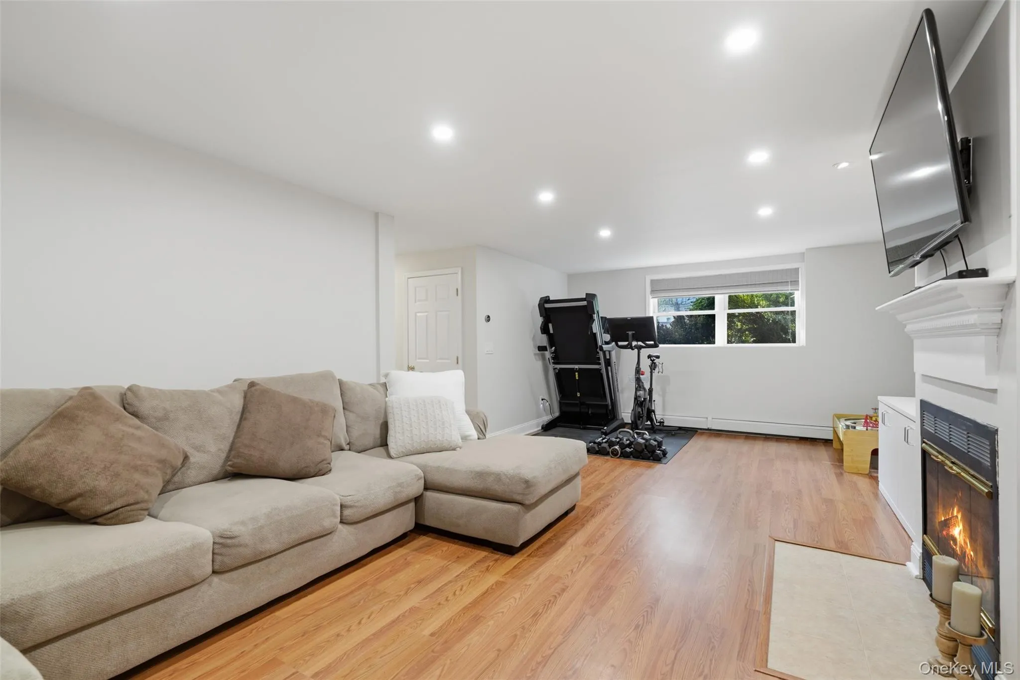 Recessed lighting, wood-finish flooring, and a window with exterior visibility Recessed lighting, wood-finish flooring, and a window with exterior visibility