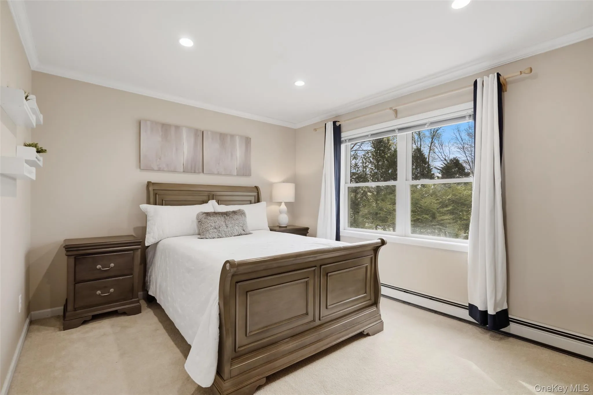 Recessed lighting, crown molding, double-pane window, baseboard heating, and carpet flooring Recessed lighting, crown molding, double-pane window, baseboard heating, and carpet flooring
