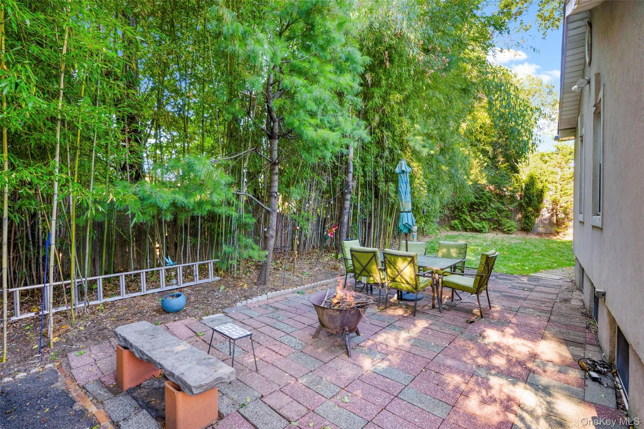 View of patio featuring a fire pit and outdoor dining space View of patio featuring a fire pit and outdoor dining space