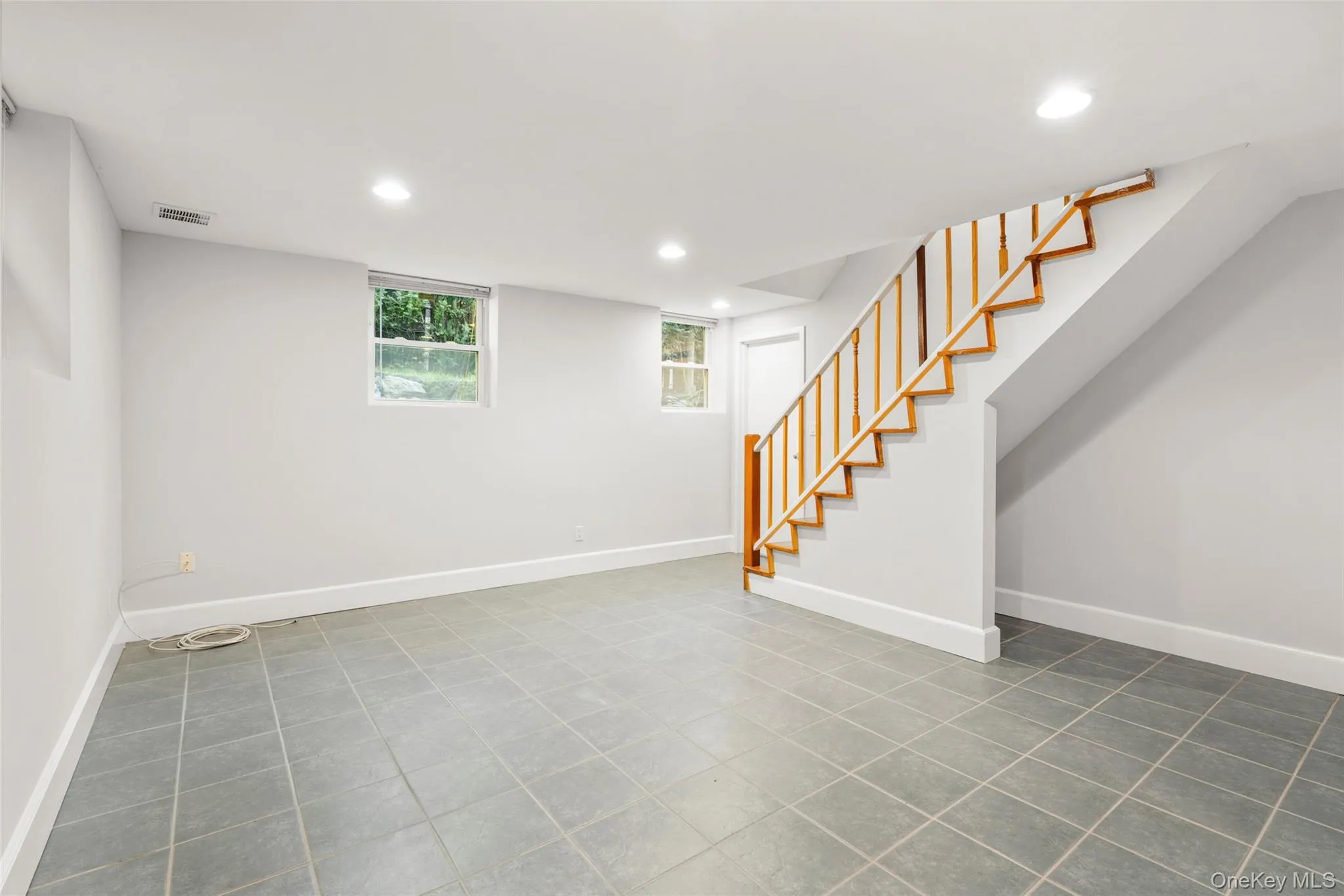 Lower level basement with access to the backyard and garages. Lower level basement with access to the backyard and garages.