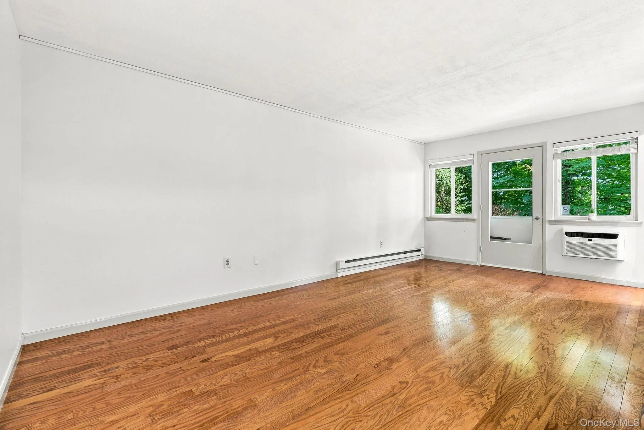 Spacious living room with door out to deck. Spacious living room with door out to deck.