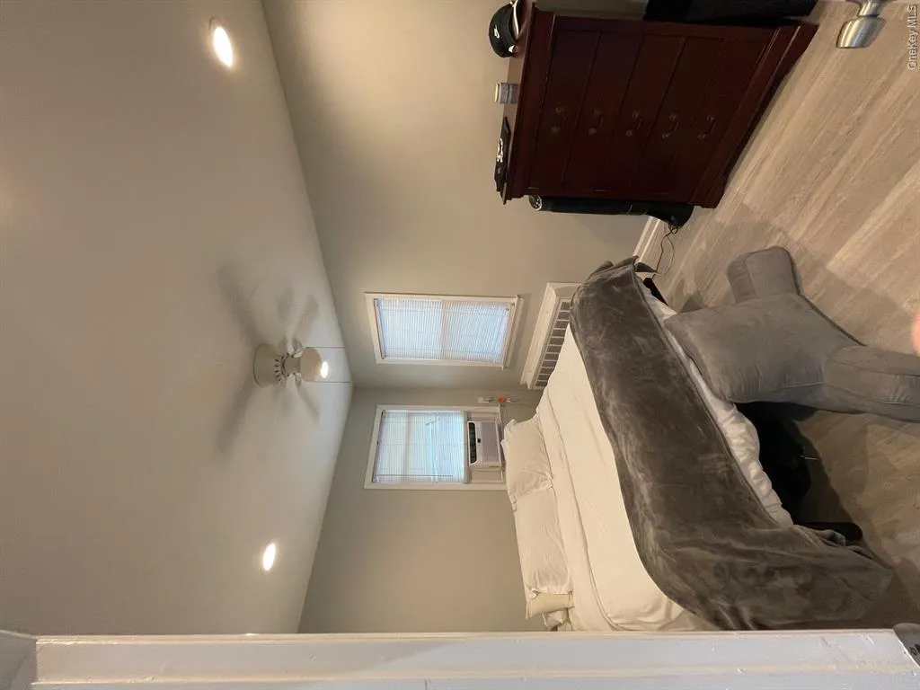 Bedroom featuring radiator heating unit, recessed lighting, cooling unit, ceiling fan, and baseboards Bedroom featuring radiator heating unit, recessed lighting, cooling unit, ceiling fan, and baseboards