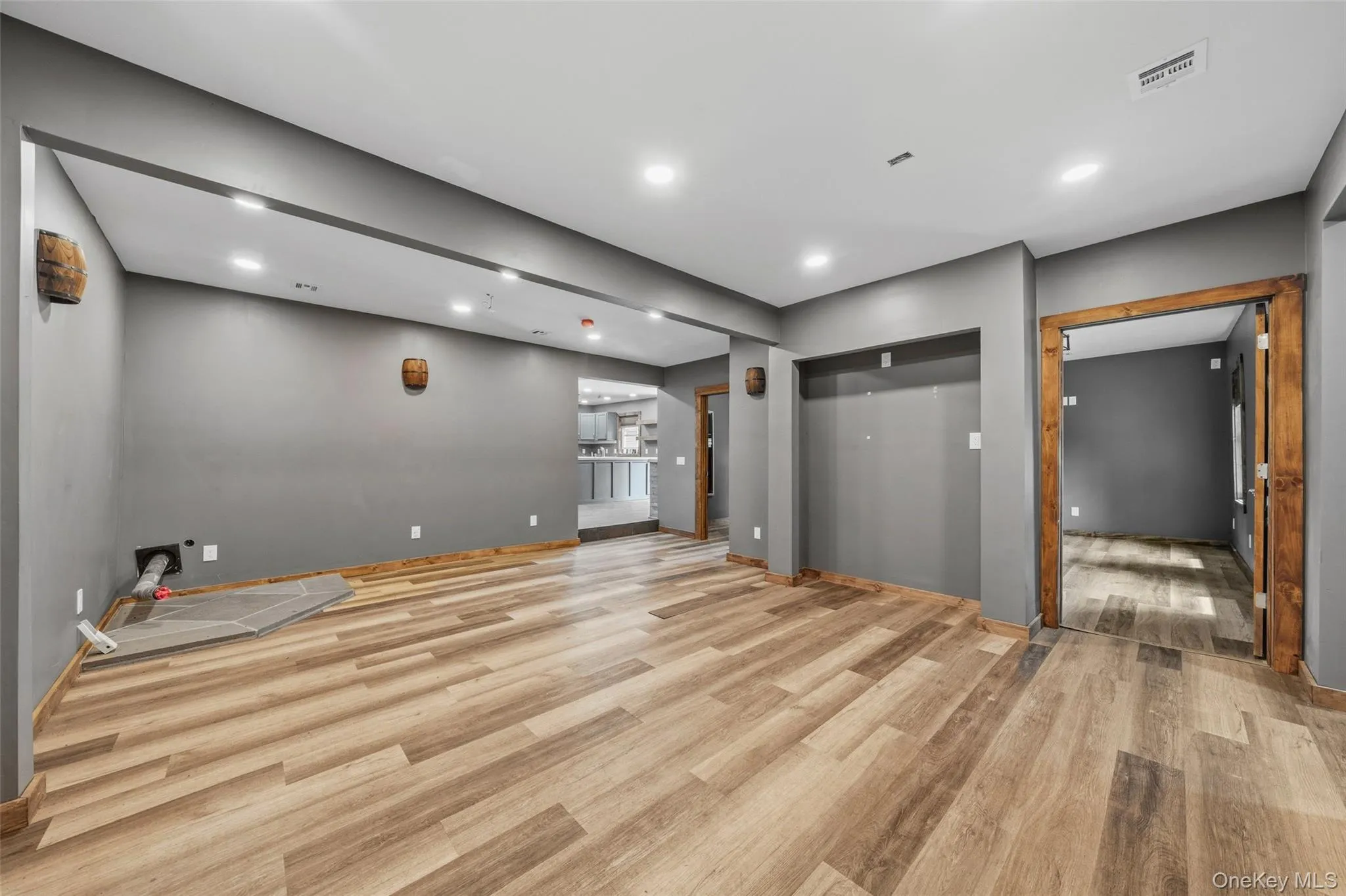 Living room with recessed lighting, luxury vinyl flooring, and pellet stove hook-up Living room with recessed lighting, luxury vinyl flooring, and pellet stove hook-up