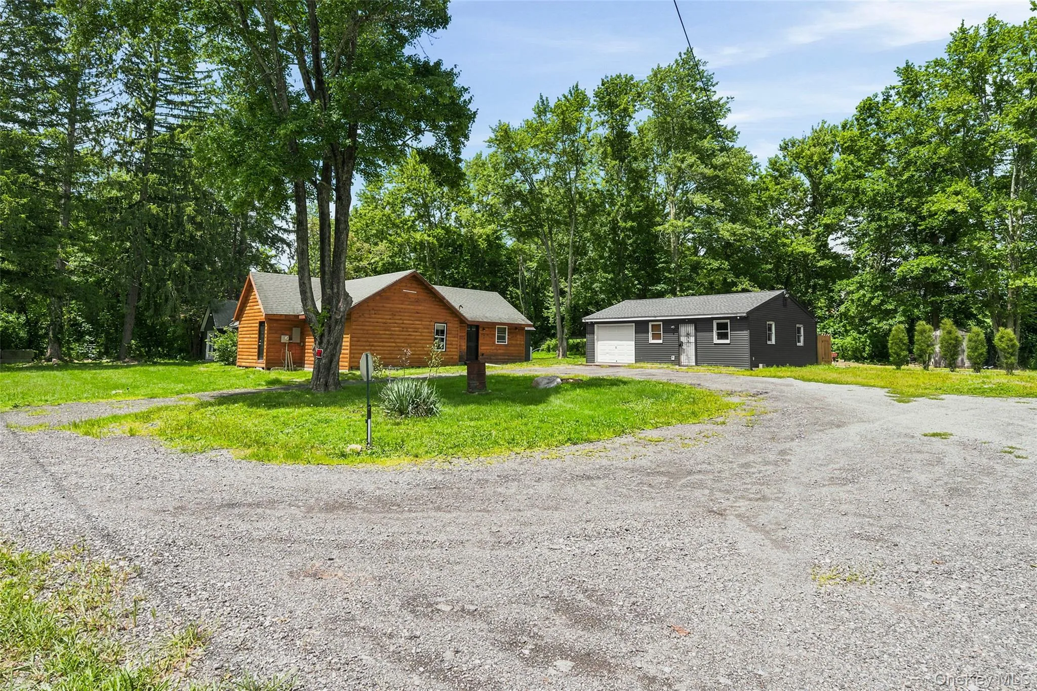 Charming two-toned property featuring ample driveway space for parking multiple cars as well as oversized vehicles and an oversized garage Charming two-toned property featuring ample driveway space for parking multiple cars as well as oversized vehicles and an oversized garage