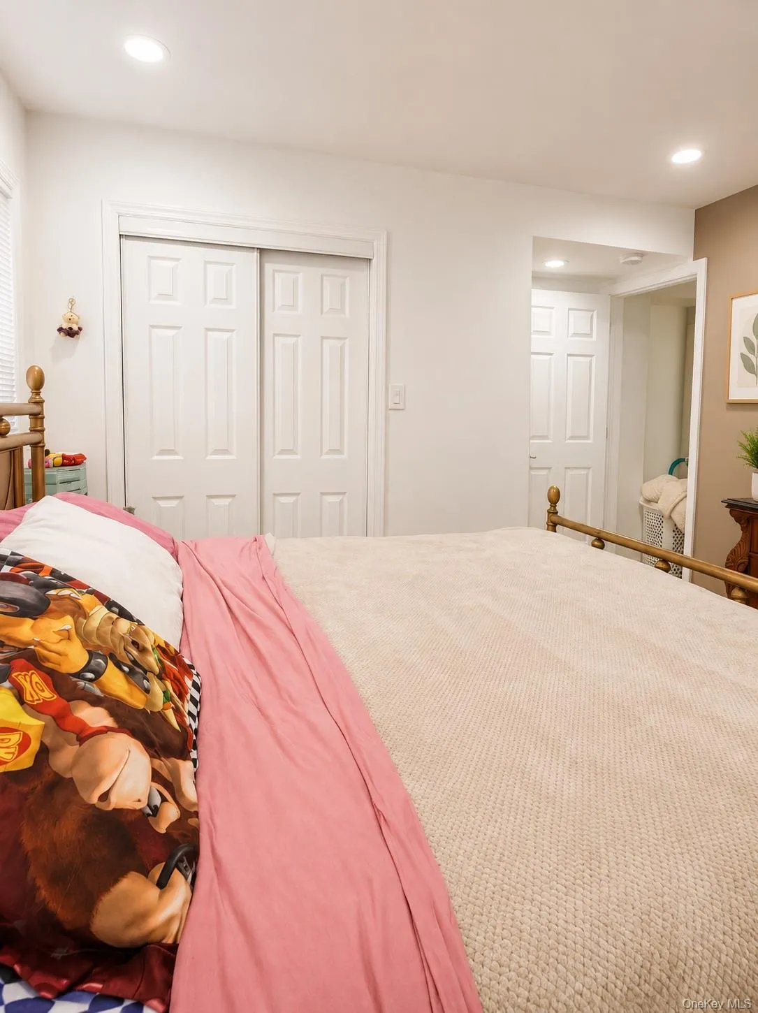 Room featuring recessed lighting, paneled sliding closet doors, and a secondary doorway Room featuring recessed lighting, paneled sliding closet doors, and a secondary doorway