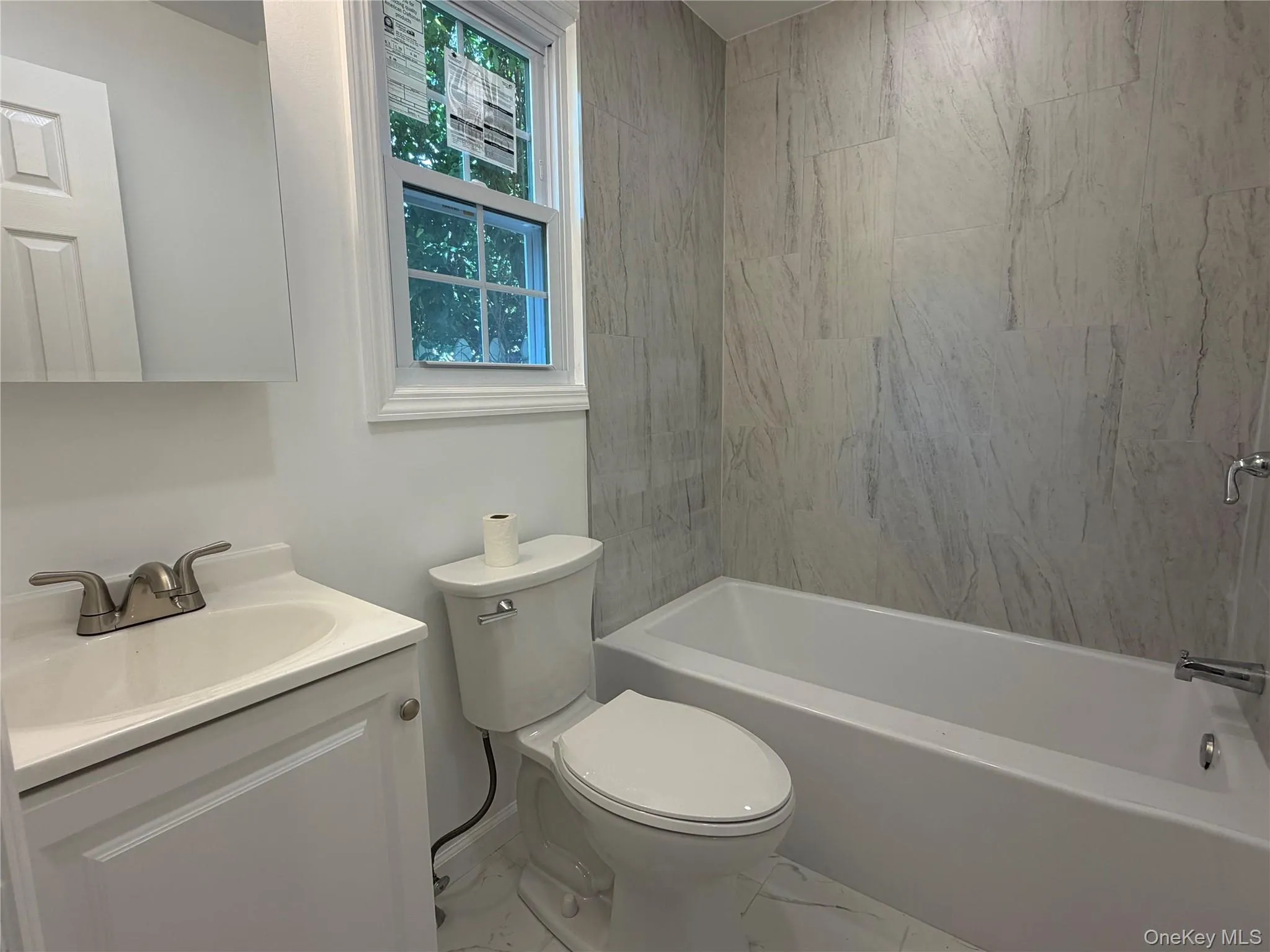 Renovated bathroom with marble tile Renovated bathroom with marble tile